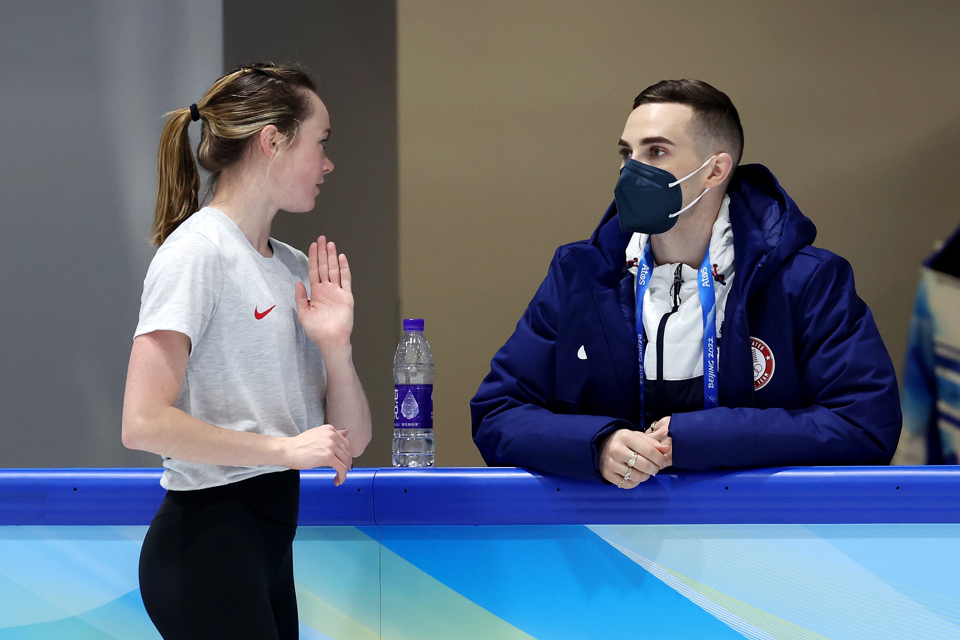 Mariah Bell of Team United States talks with coach and former Olympic figure skater Adam Rippon during a practice session ahead of the Beijing 2022 Winter Olympic Games at Capital Indoor Stadium on February 01, 2022 in Beijing, China.