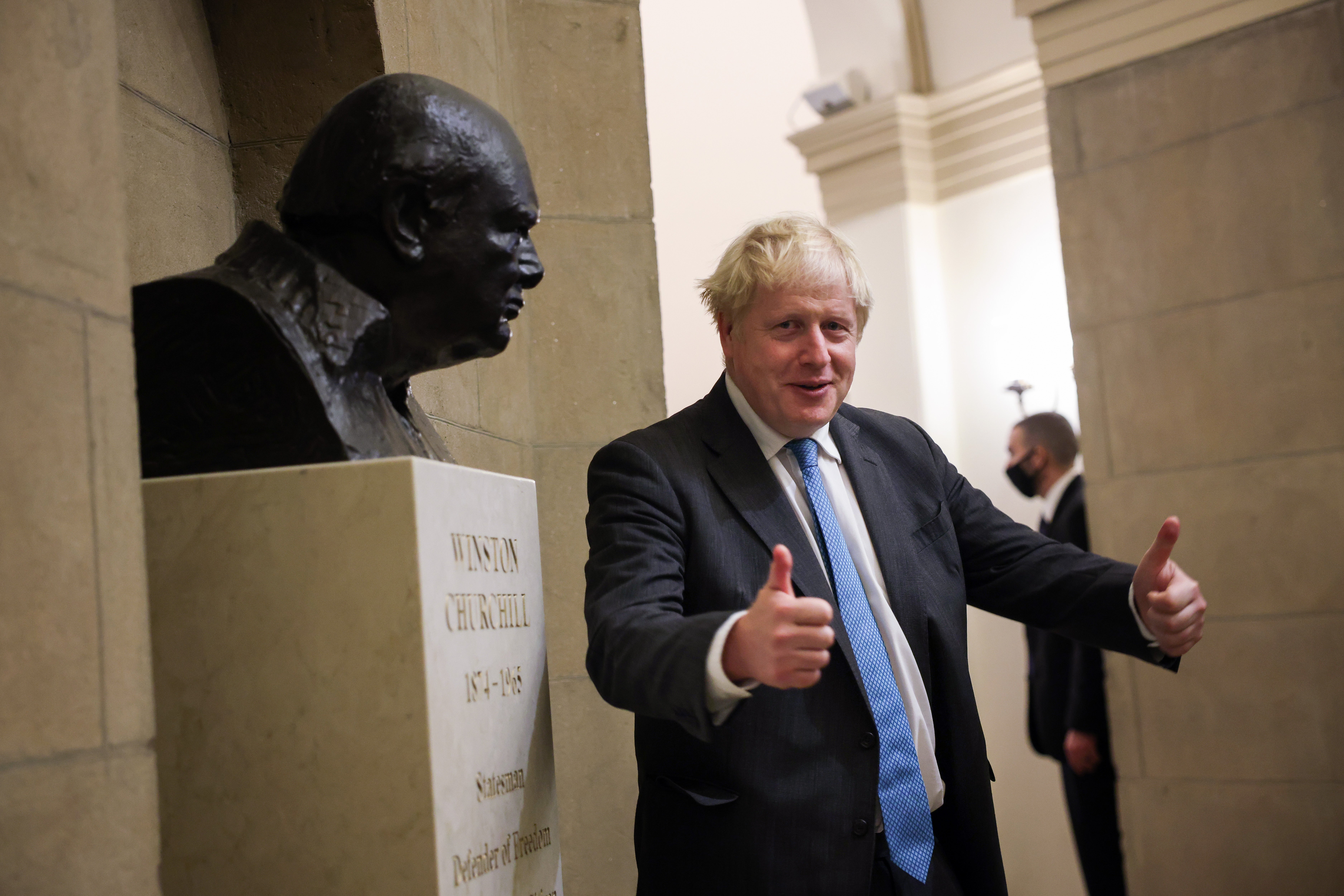 British Prime Minister Boris Johnson stops to look at a bust of Winston Churchill during a trip to Washington in September 202