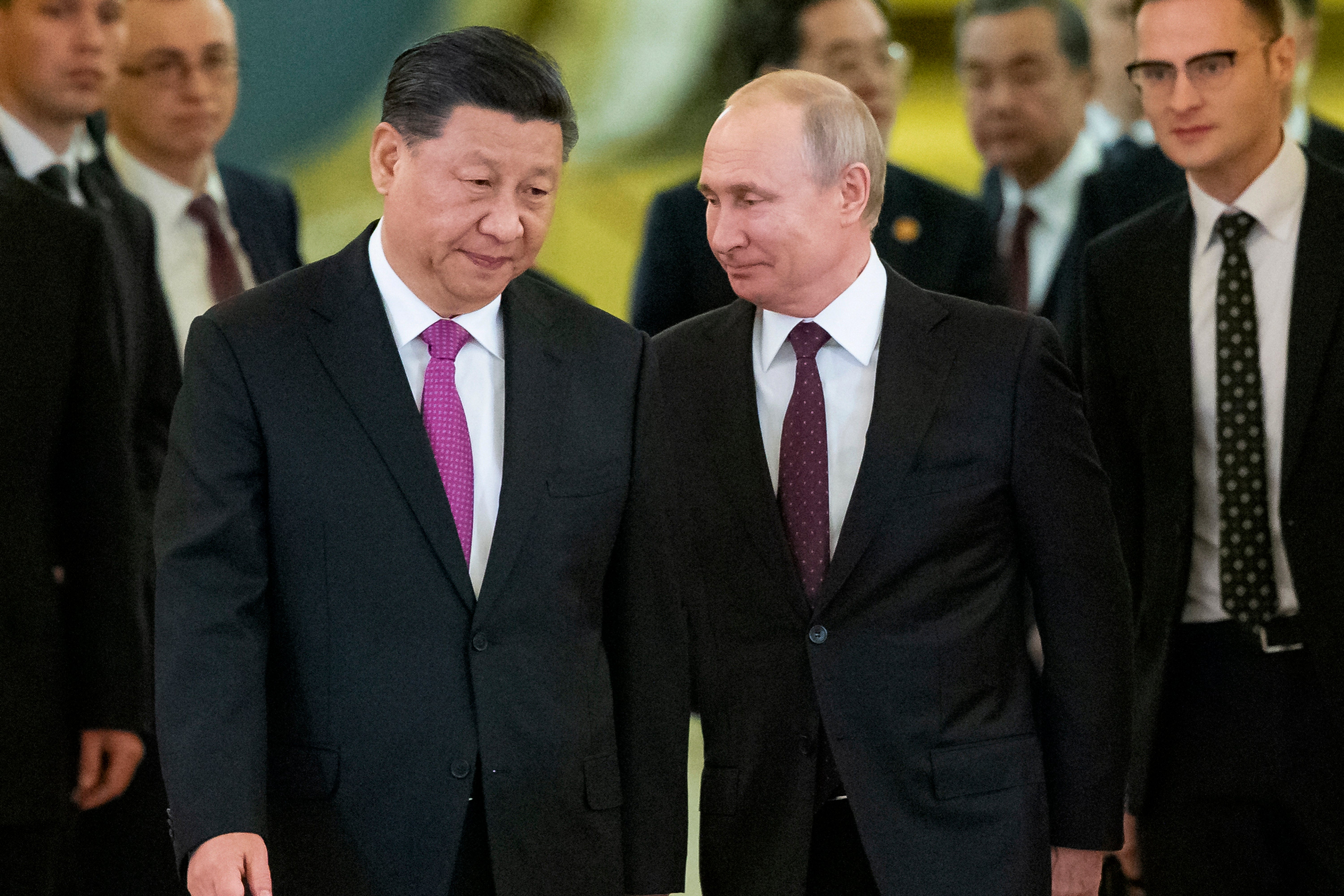 Xi and Putin enter a hall for talks in the Kremlin in 2019