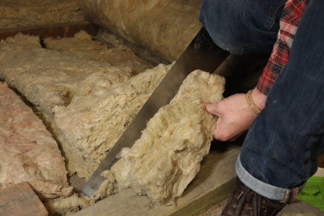 Laying loft insulation (Philip Toscano/PA)