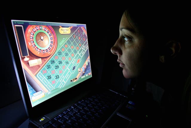 A woman uses an internet gambling website to play online roulette (Gareth Fuller/PA)