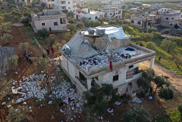 <p>People inspect a destroyed house following an operation by the US military in the Syrian village of Atmeh, after US special forces conducted a large-scale raid overnight </p>