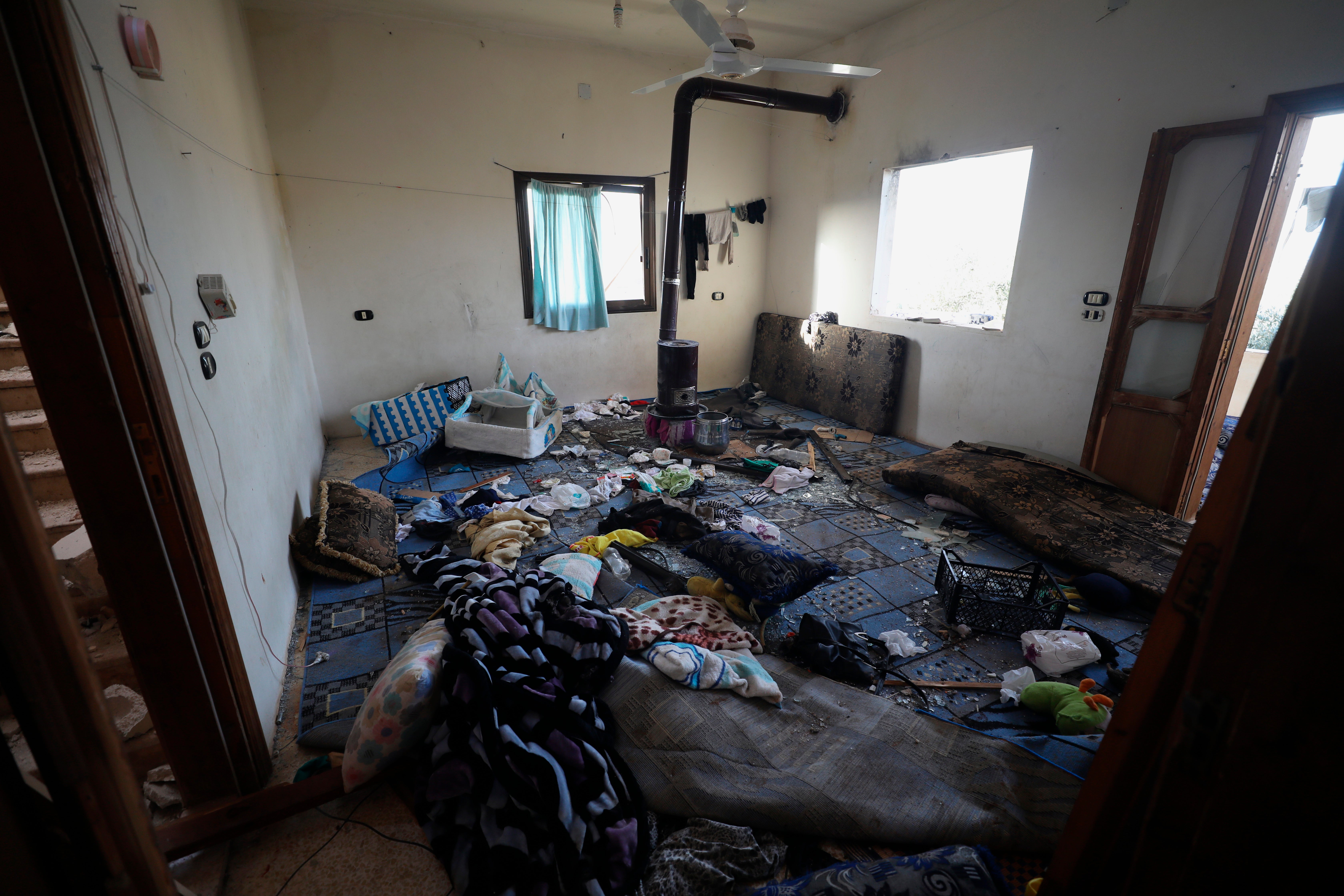 A damaged room and windows are seen inside a house after an operation by the U.S. military in the Syrian village of Atmeh in Idlib province, Syria, Thursday, Feb. 3, 2022