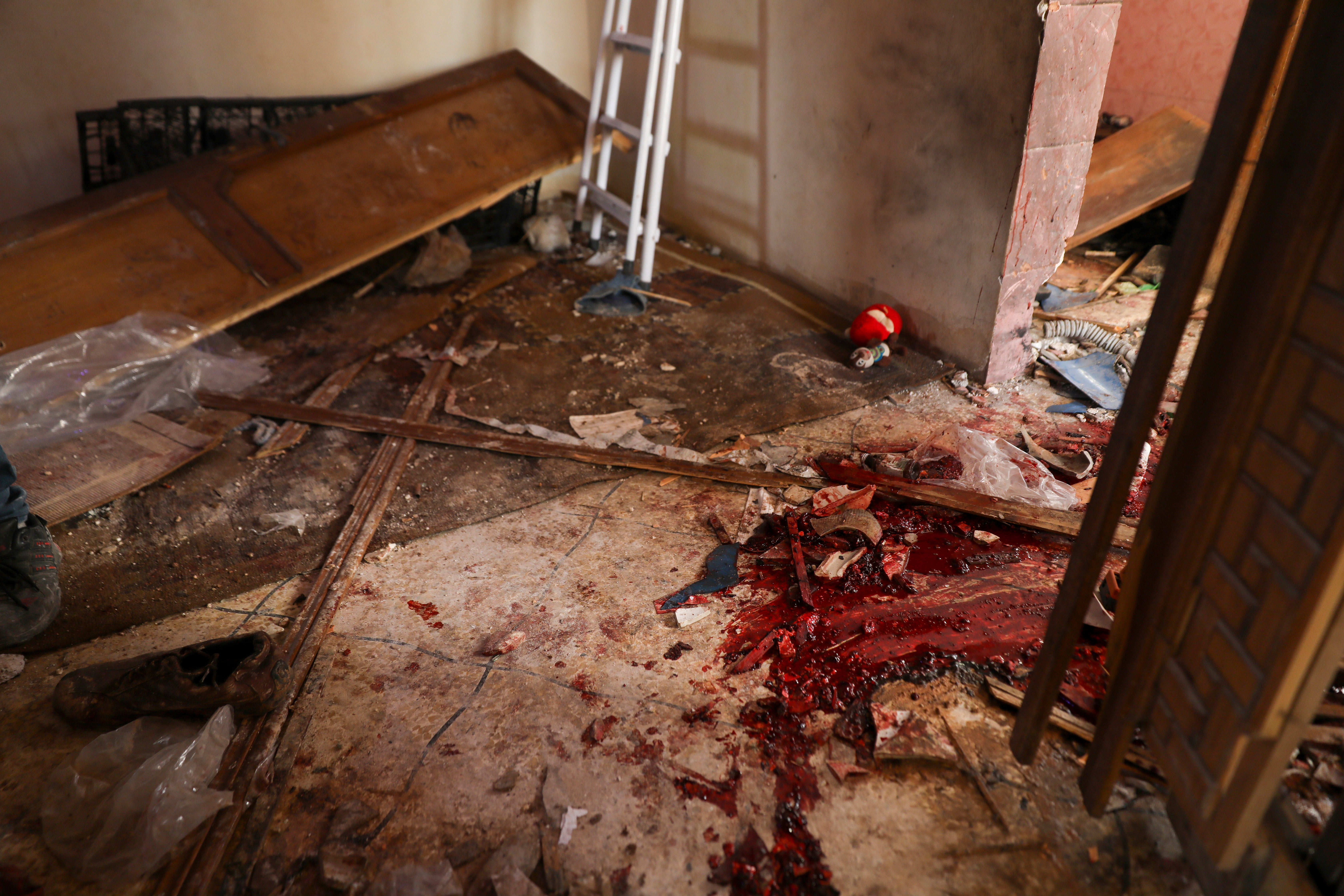 Blood covers the floor of a destroyed house after an operation by the U.S. military in the Syrian village of Atmeh in Idlib province, Syria, Thursday, Feb. 3, 2022