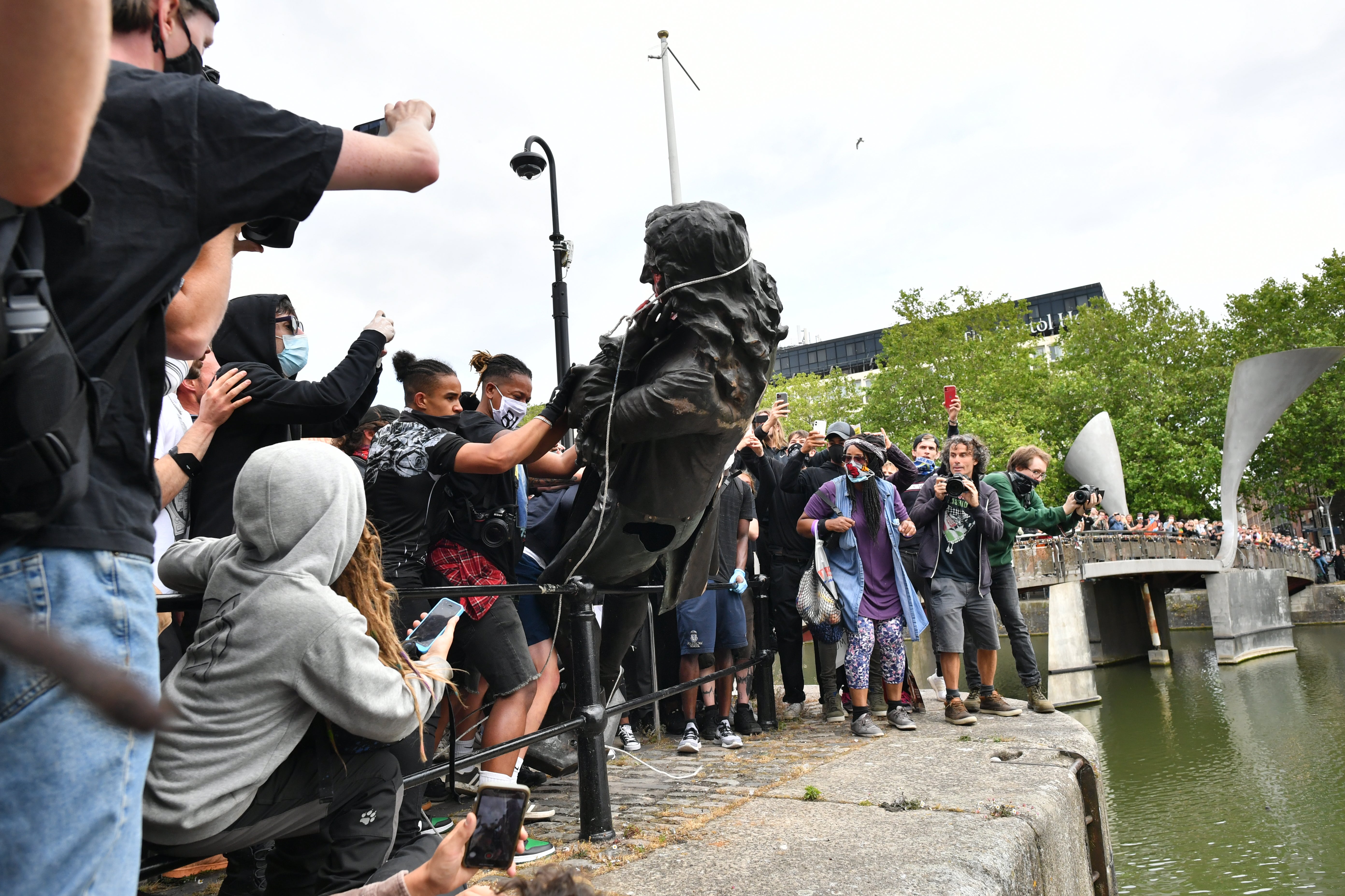 Protesters throw the statue of Edward Colston into Bristol harbour during a Black Lives Matter protest in June 2020 (Ben Birchall/PA)