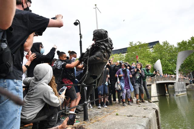 Protesters throw the statue of Edward Colston into Bristol harbour during a Black Lives Matter protest in June 2020 (Ben Birchall/PA)