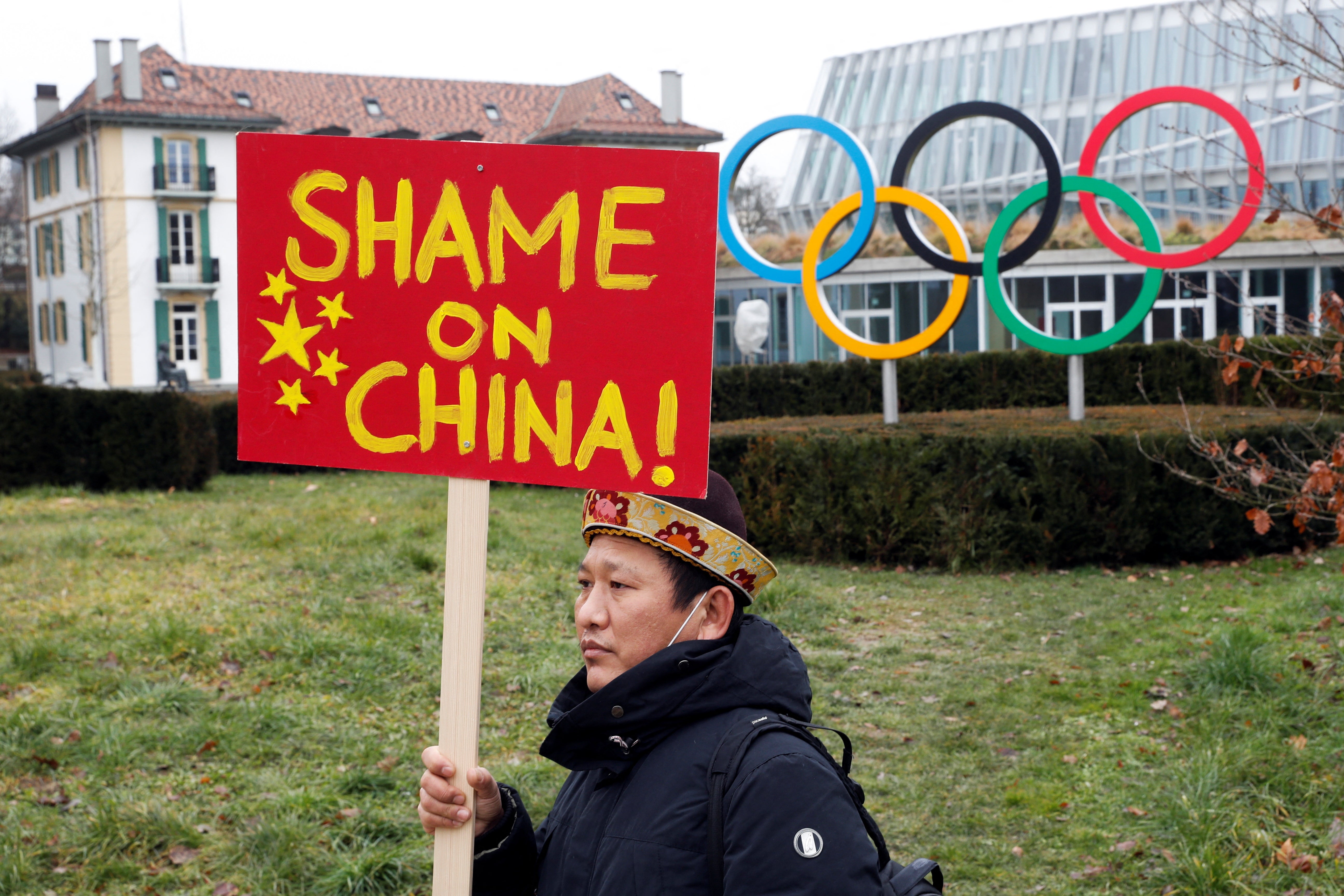 A member of Tibetan community protests in front of the headquarters of the International Olympic Committee (IOC) in Lausanne, Switzerland