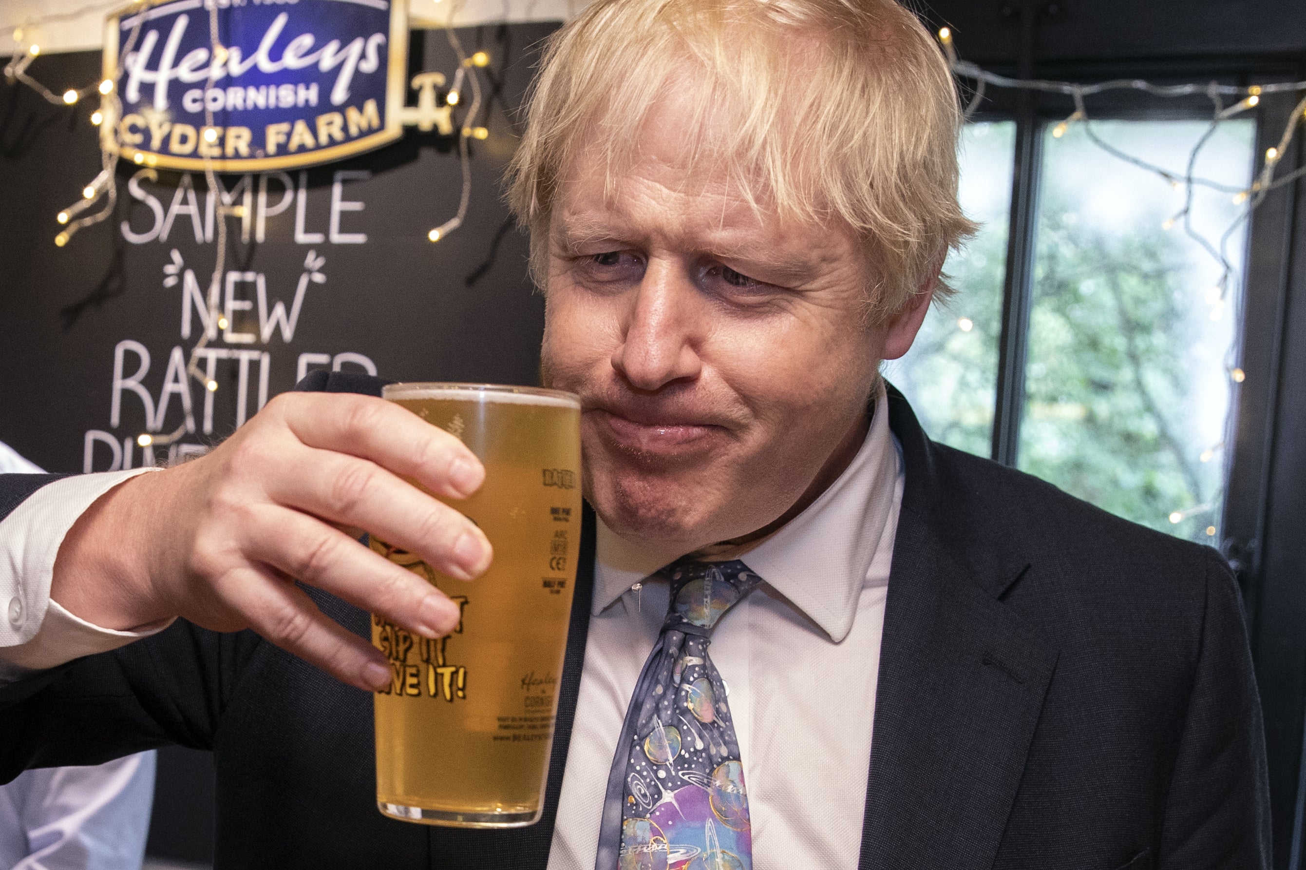 File photo: British PM Boris Johnson drinks a pint of cider in Callestick, Cornwall, 27 November 2019