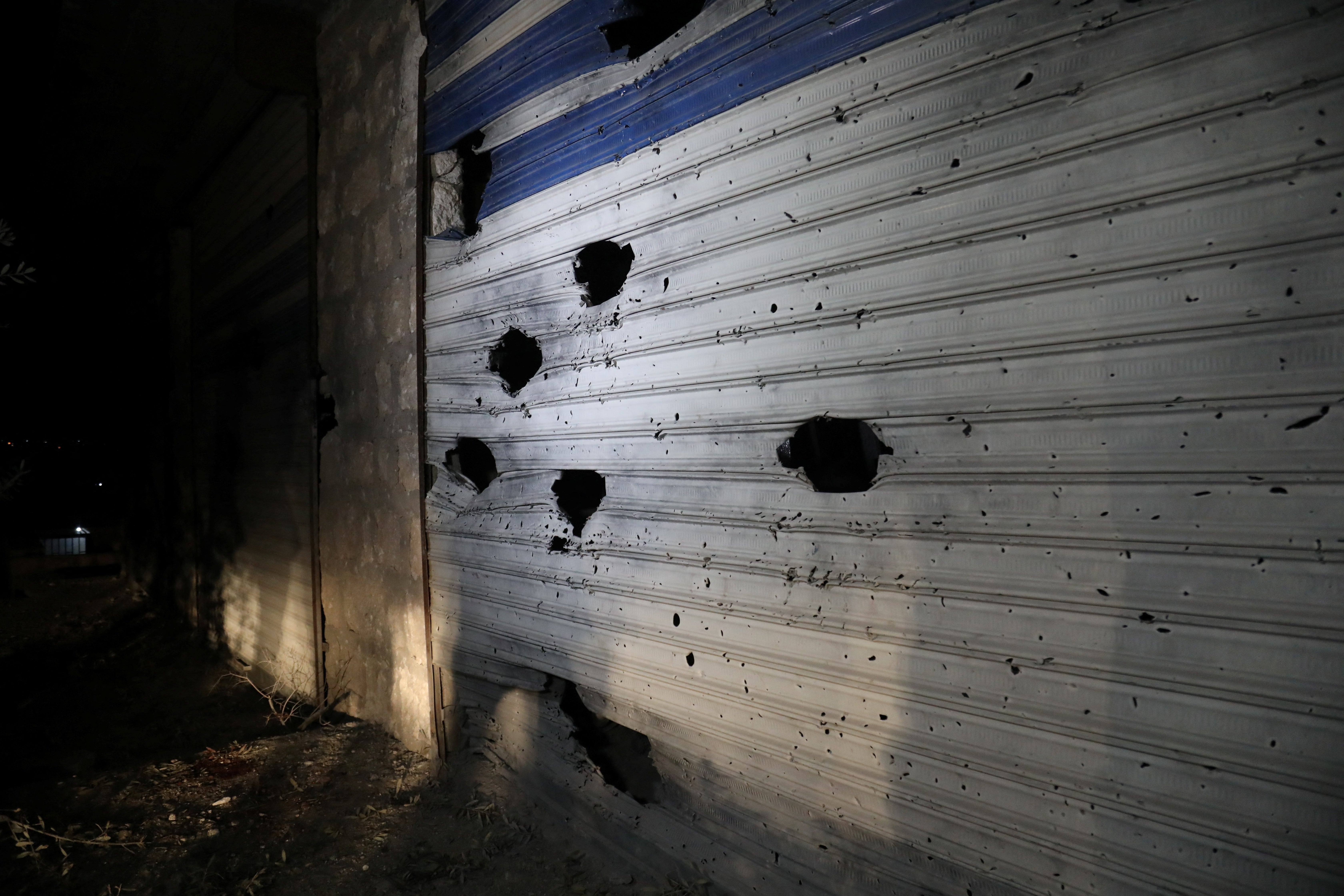 A damaged shutter is seen on a building in the aftermath of a counter-terrorism mission conducted by the U.S. Special Operations Forces in Atmeh, Syria, February 3, 2022 in this picture obtained from social media