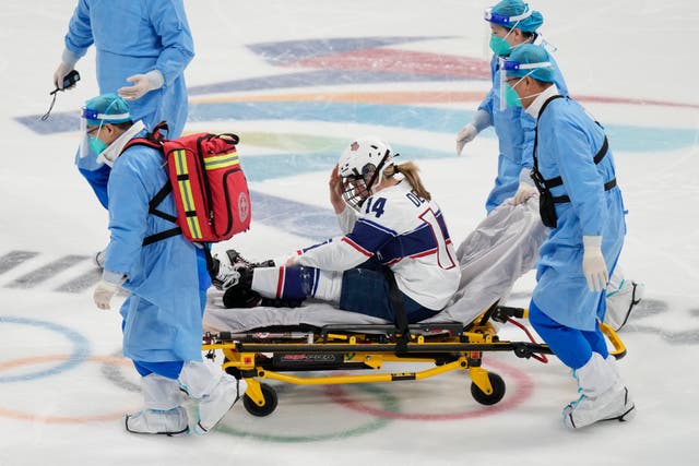 <p>Brianna Decker (14) is taken off the ice after being injured during a preliminary round women's hockey game against Finland at the 2022 Winter Olympics, Thursday, Feb. 3, 2022, in Beijing.</p>