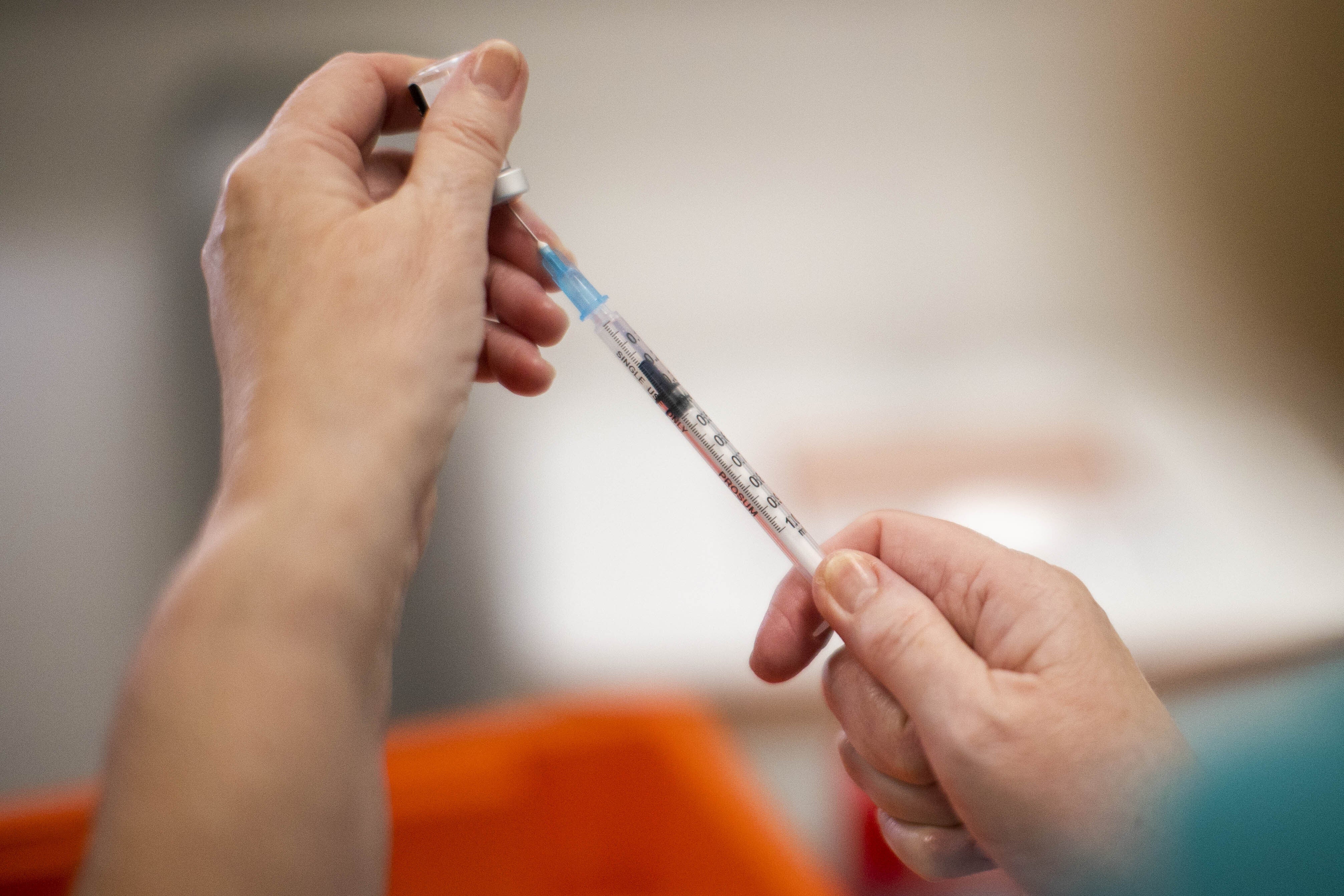 A vaccinator preparing a vial of the Pfizer/BioNTech Covid-19 vaccine (Liam McBurney/PA)