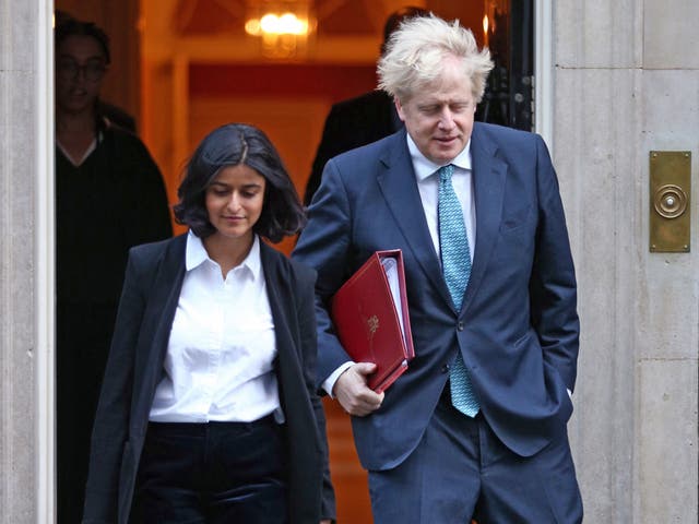 <p>Boris Johnson walking out of Downing Street with Munira Mirza</p>