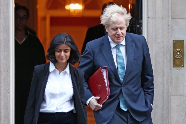 <p>Boris Johnson walking out of Downing Street with Munira Mirza</p>