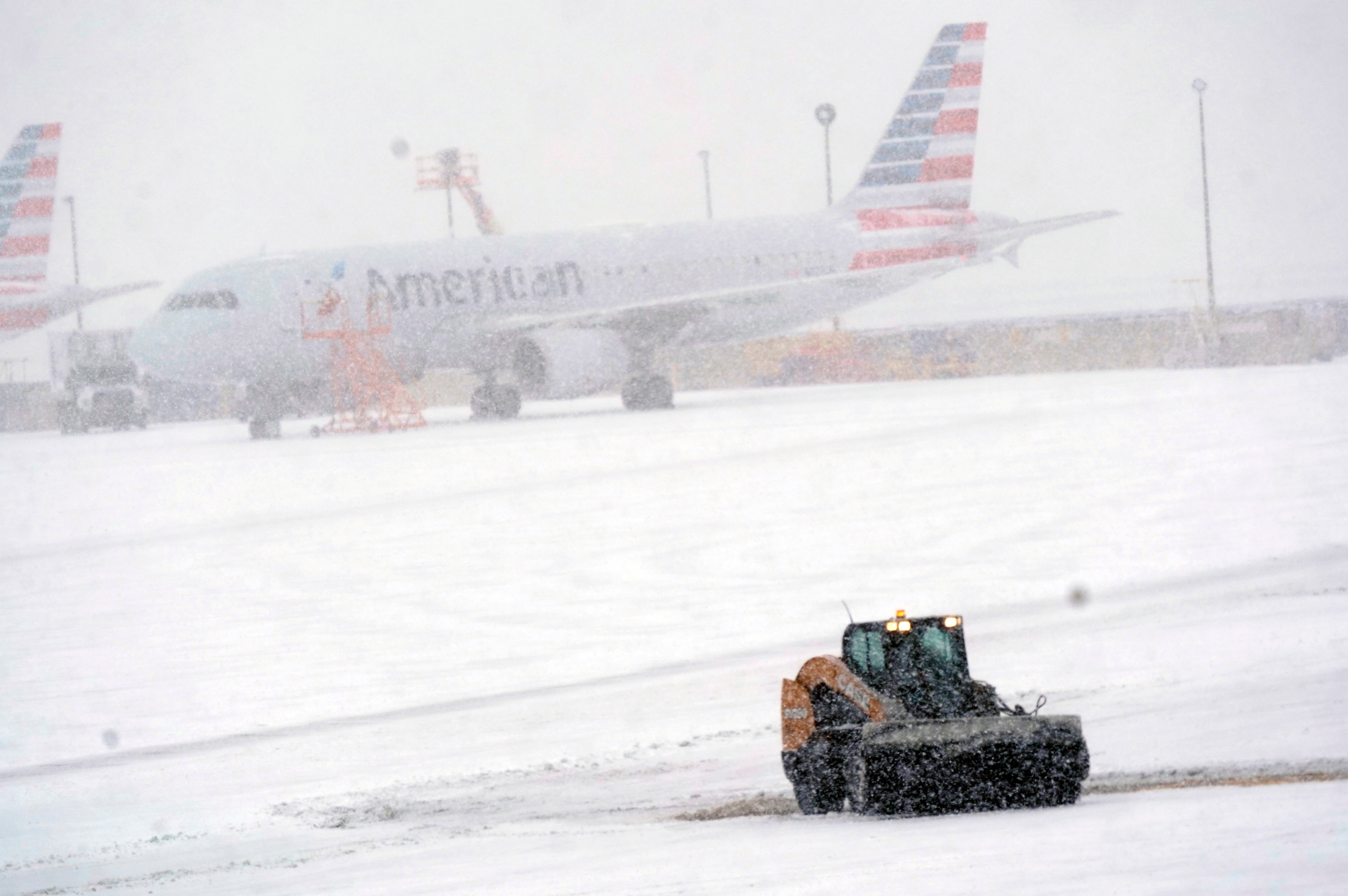 Snow and ice are cleared from the tarmac at Dallas Fort WorthAirport in Texas, on 3 February.