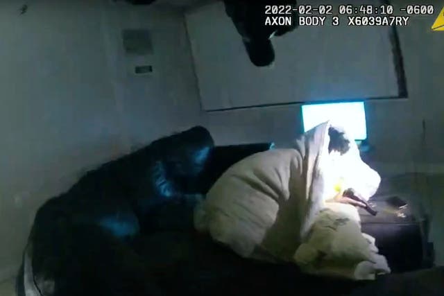 <p>In this image taken from the Minneapolis police department body camera video and released by the city of Minneapolis, 22-year-old Amir Locke is seen wrapped in a blanket on a couch holding a gun moments before he was fatally shot by Minneapolis police</p>