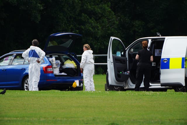 Police forensic officers in the Sarn area of Bridgend, south Wales, near to where five-year-old Logan Mwangi was found in the Ogmore River (PA)