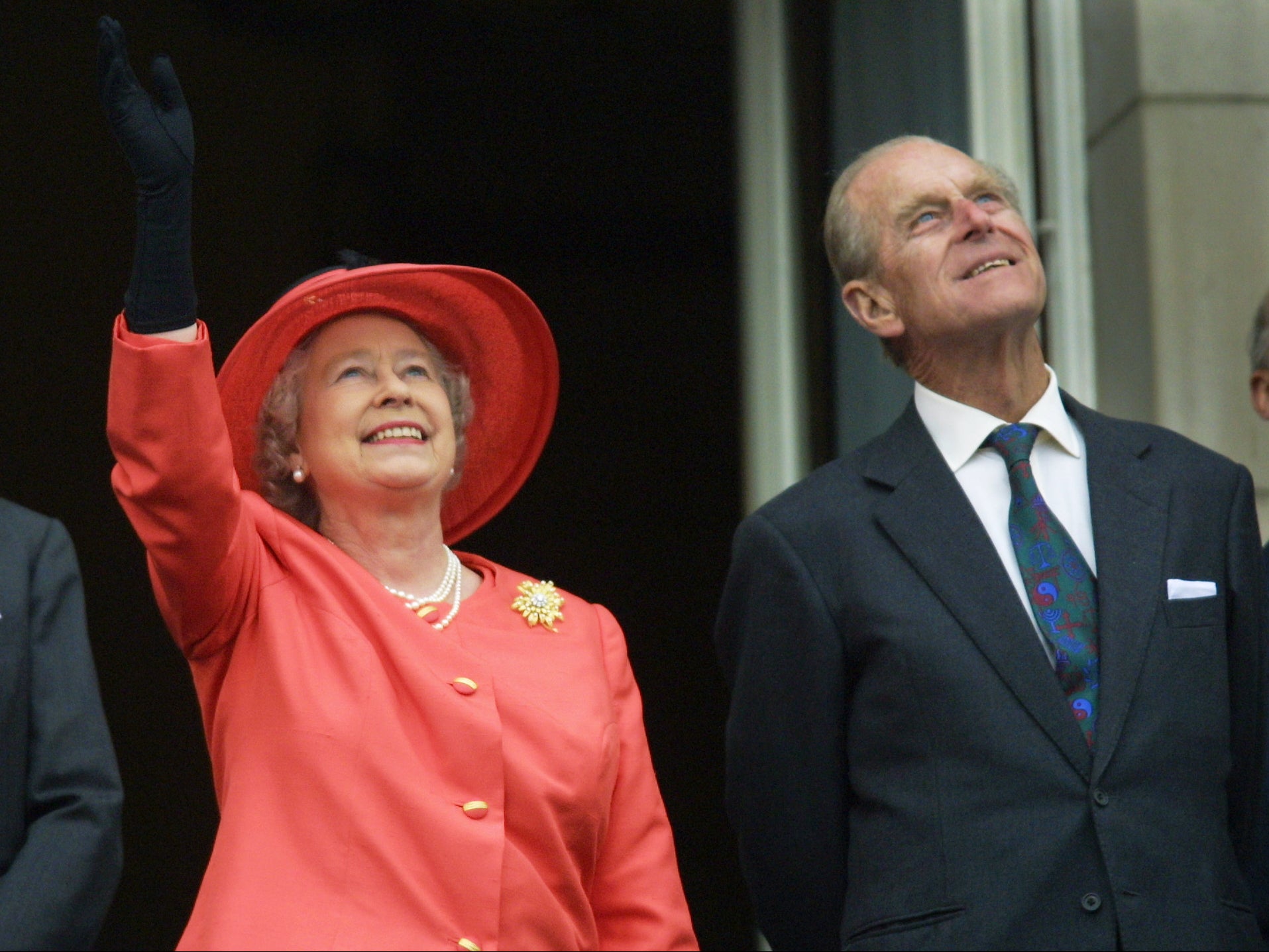 Queen Elizabeth II and Prince Philip look up from the balcony of Buckingham Palace as Concorde flies past during the Golden Jubilee celebrations in London