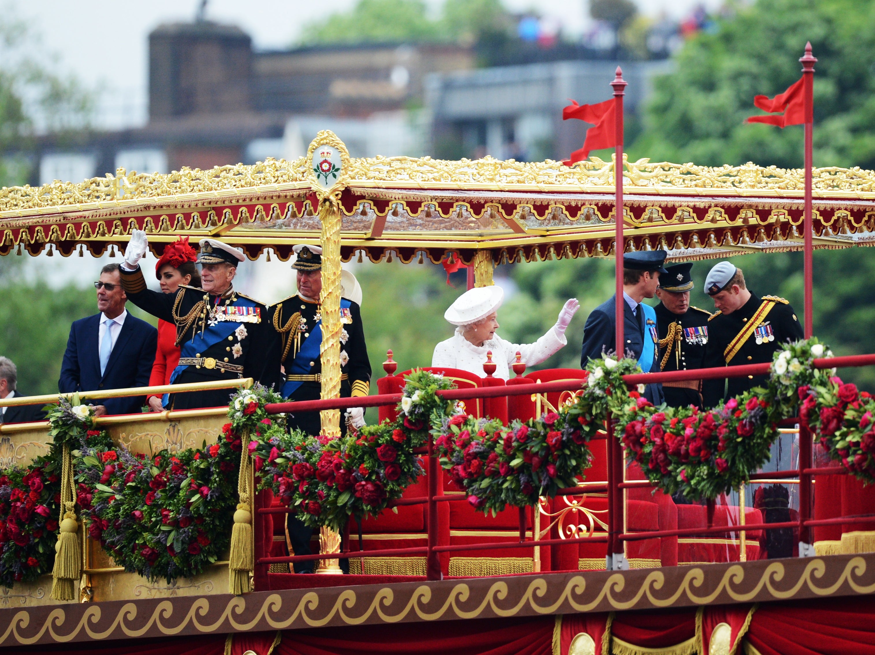 Members of the British royal family (3rdL-R) Catherine, Duchess of Cambridge, Prince Philip, Duke of Edinburgh, Prince Charles, Prince of Wales, Britain's Queen Elizabeth II, Prince William and Prince Harry stand aboard the royal barge 'Spirit of Chartwell' during the Thames Diamond Jubilee Pageant on the River Thame
