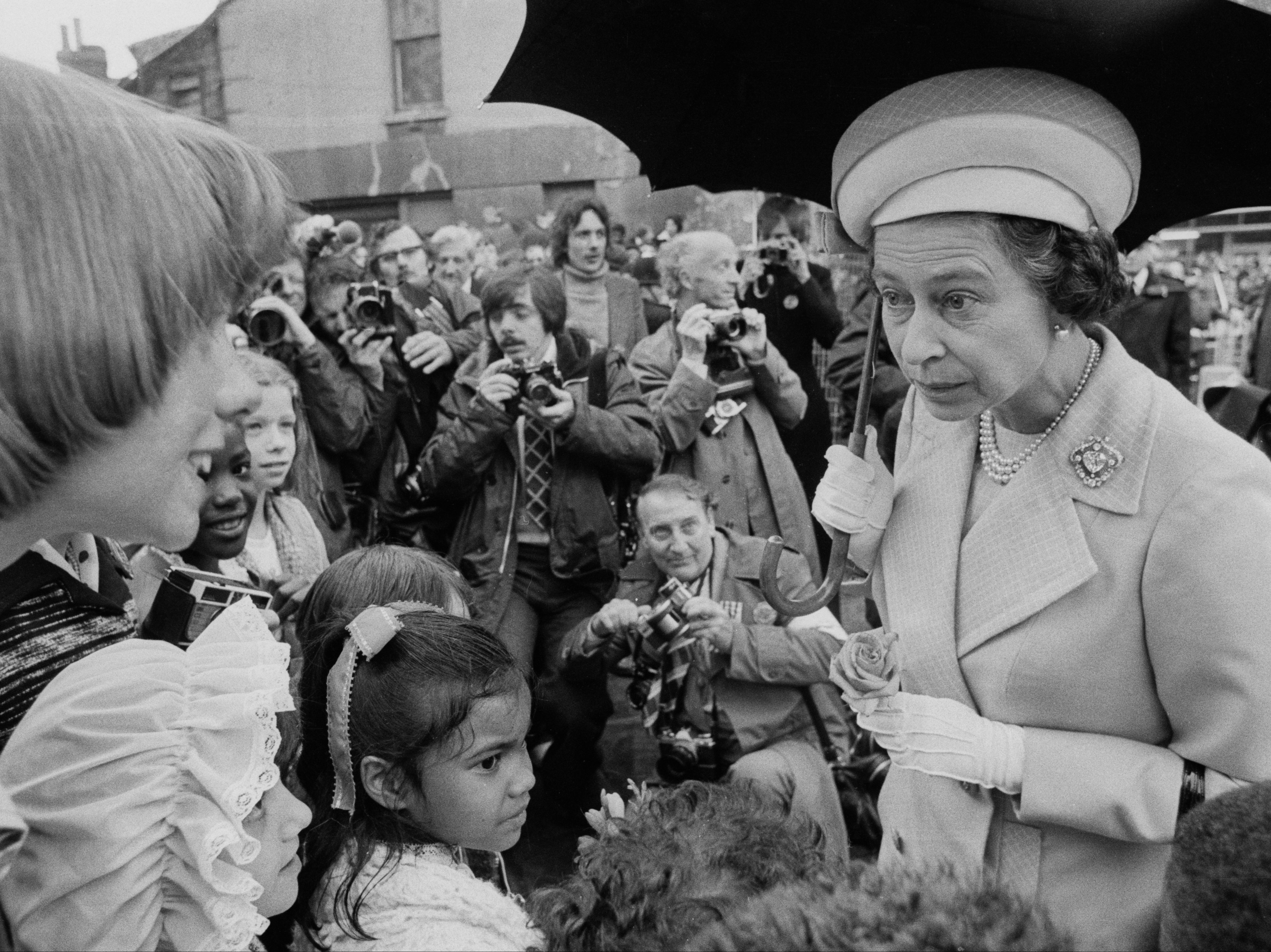 Queen Elizabeth II talking to children in Deptford, during a walkabout to commemorate her Silver Jubilee