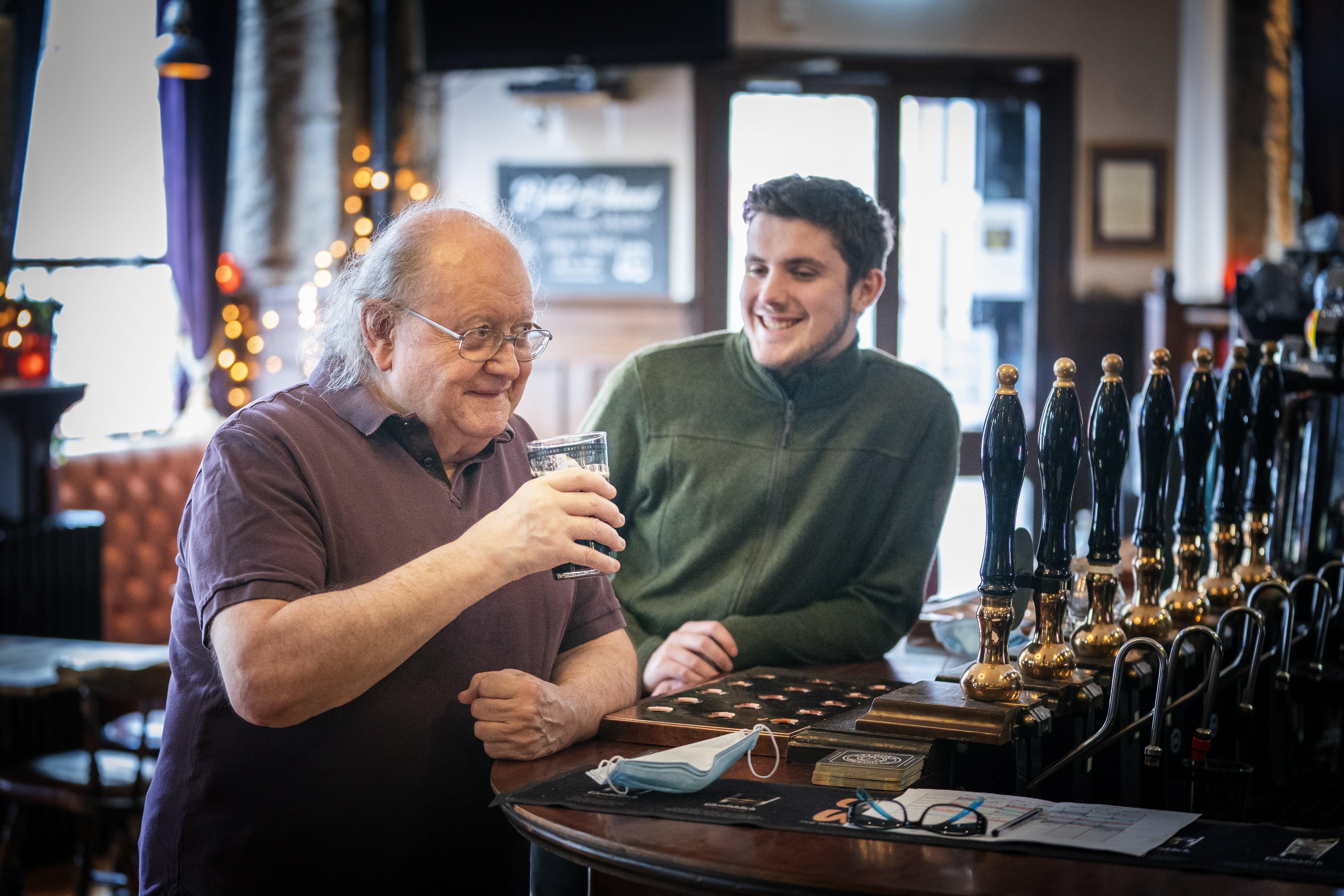 Customers drink at the bar in the No.1 High Street pub on Edinburgh’s Royal Mile (Jane Barlow/PA)