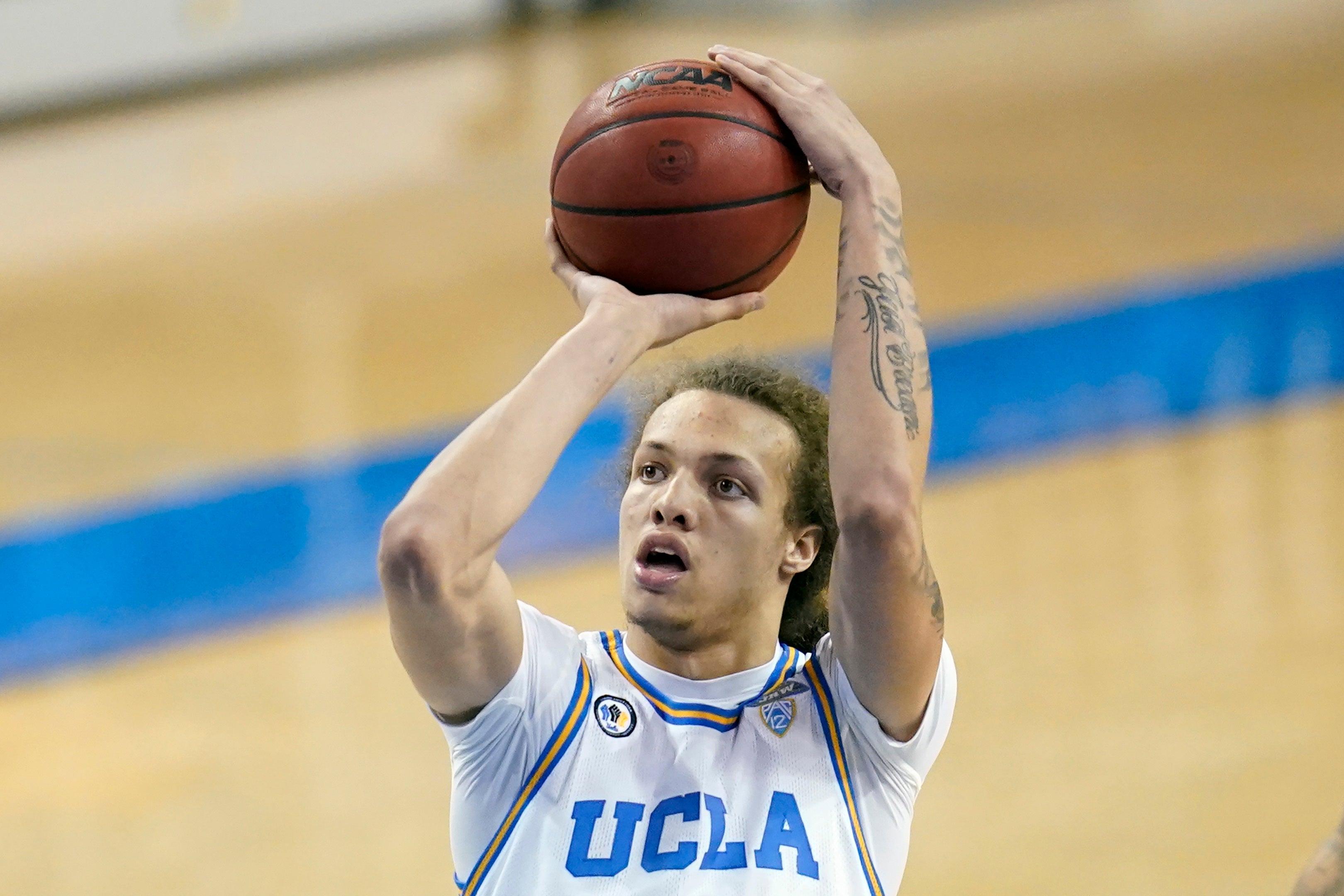 FILE - UCLA forward Mac Etienne (12) shoots the ball during the second half of an NCAA basketball game against Arizona State on Saturday, Feb. 20, 2021, in Los Angeles.