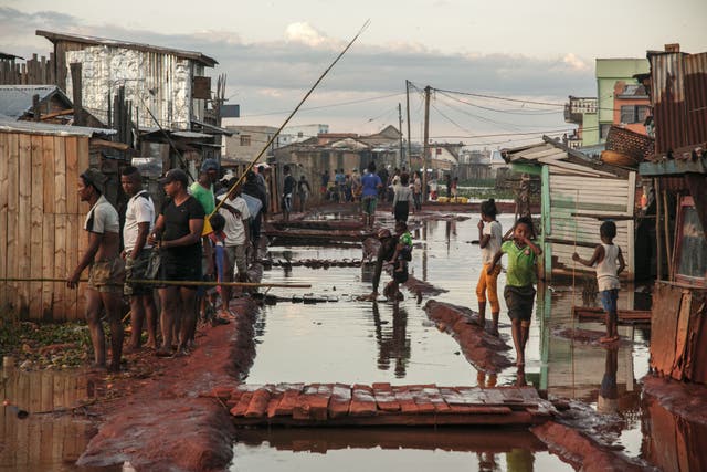 <p>Residents of the Ankasina flooded neighbourhood stand in a flood area in Antananarivo, Madagascar in late January</p>