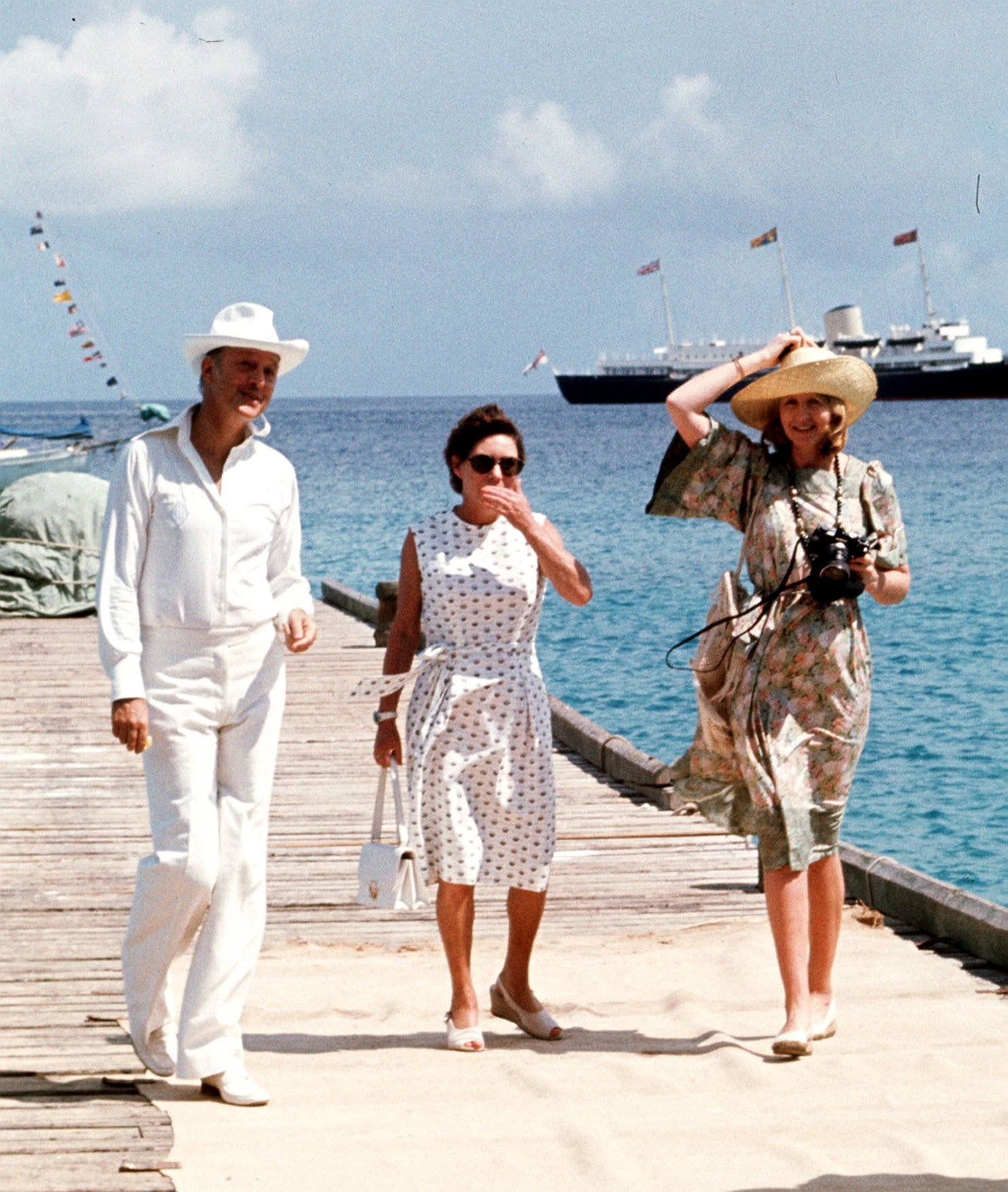 Princess Margaret and her friends Lord Colin Tennant and Lady Anne Tennant waiting on the jetty at Mustique to greet Queen during her Silver Jubilee tour (PA)