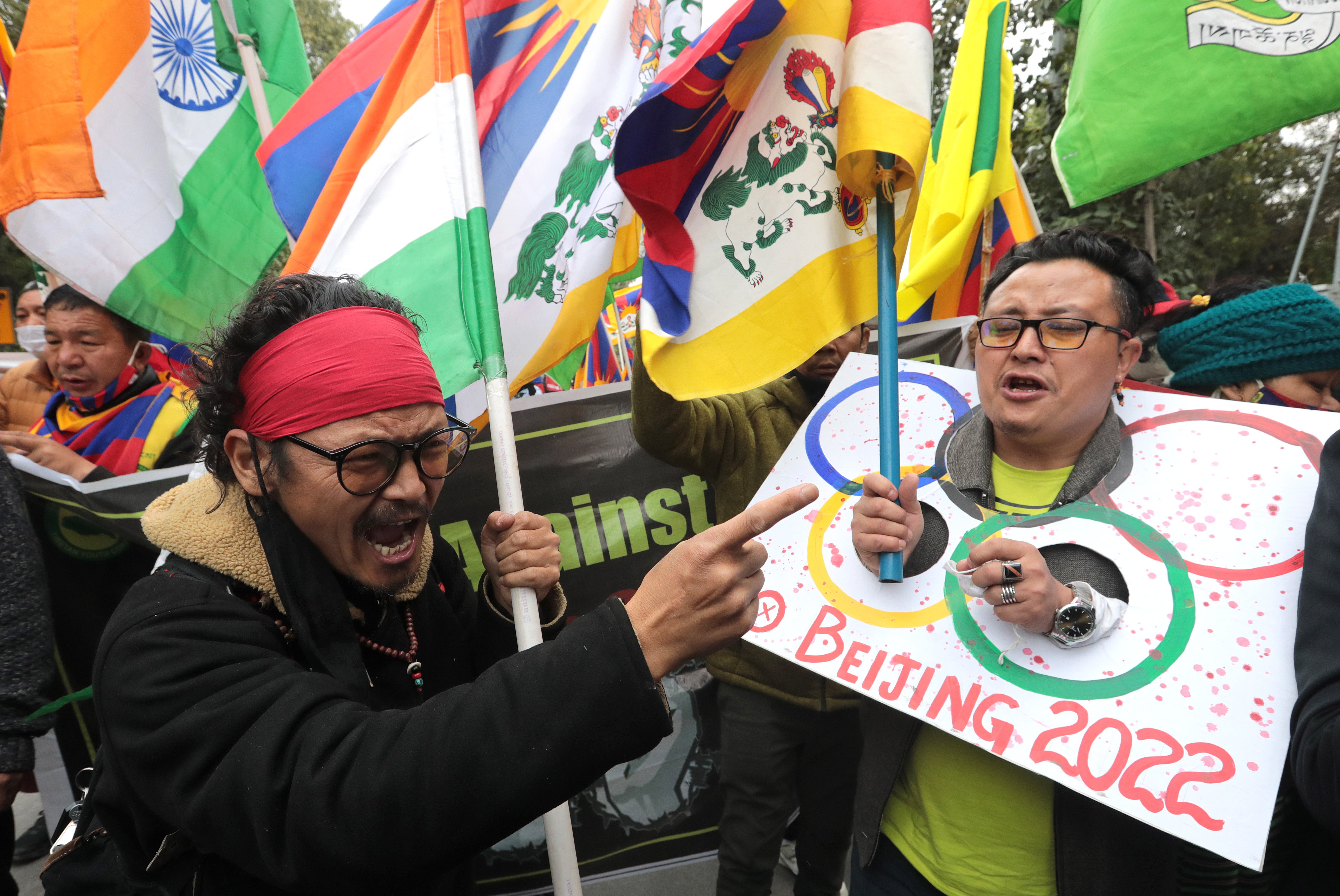 Tibetans living in exile in India take part in a protest march in Delhi against the 2022 Beijing Winter Olympics