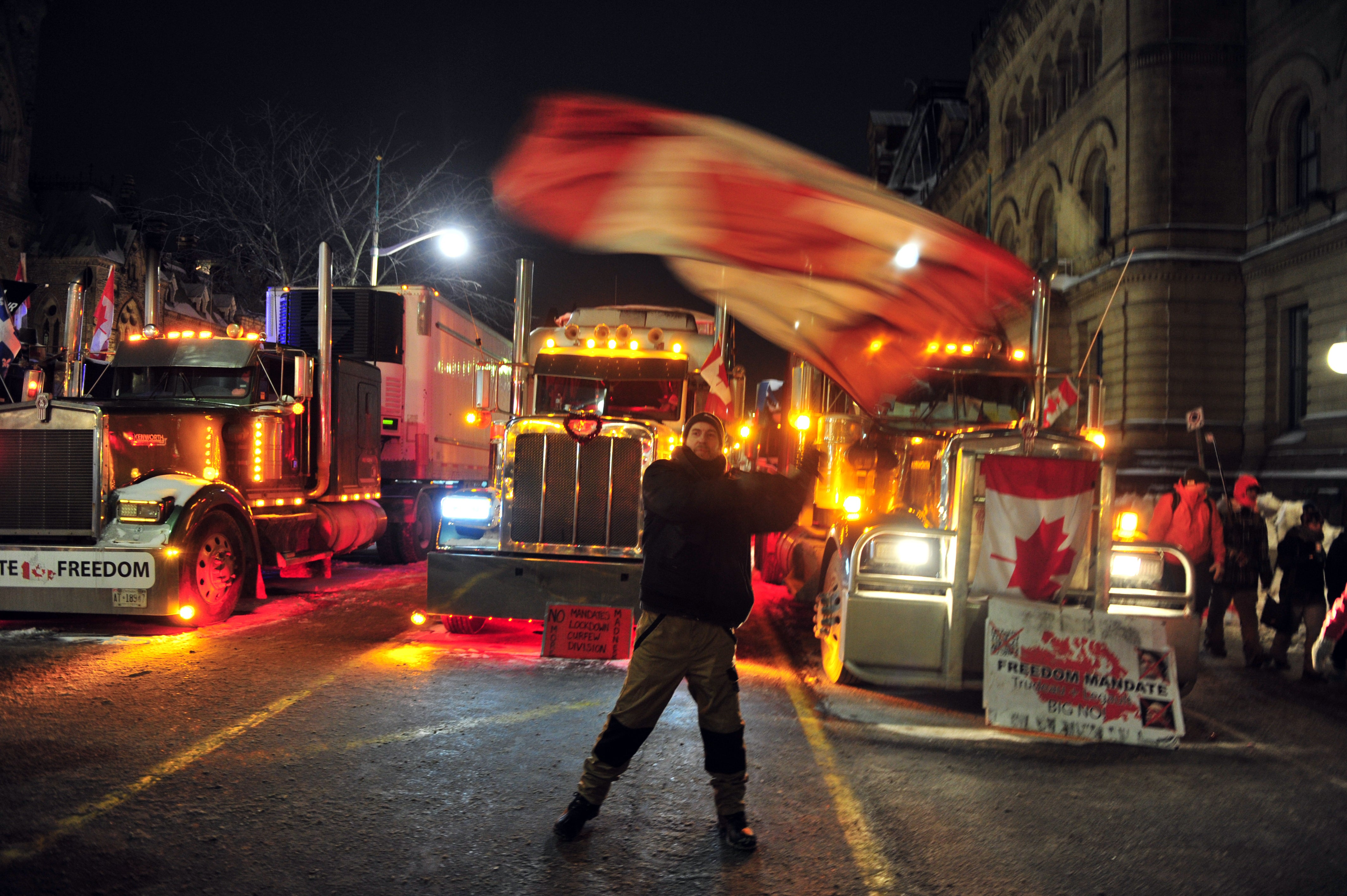 Demonstrators gather in downtown Ottawa in support of the Freedom Truck Convoy on Friday