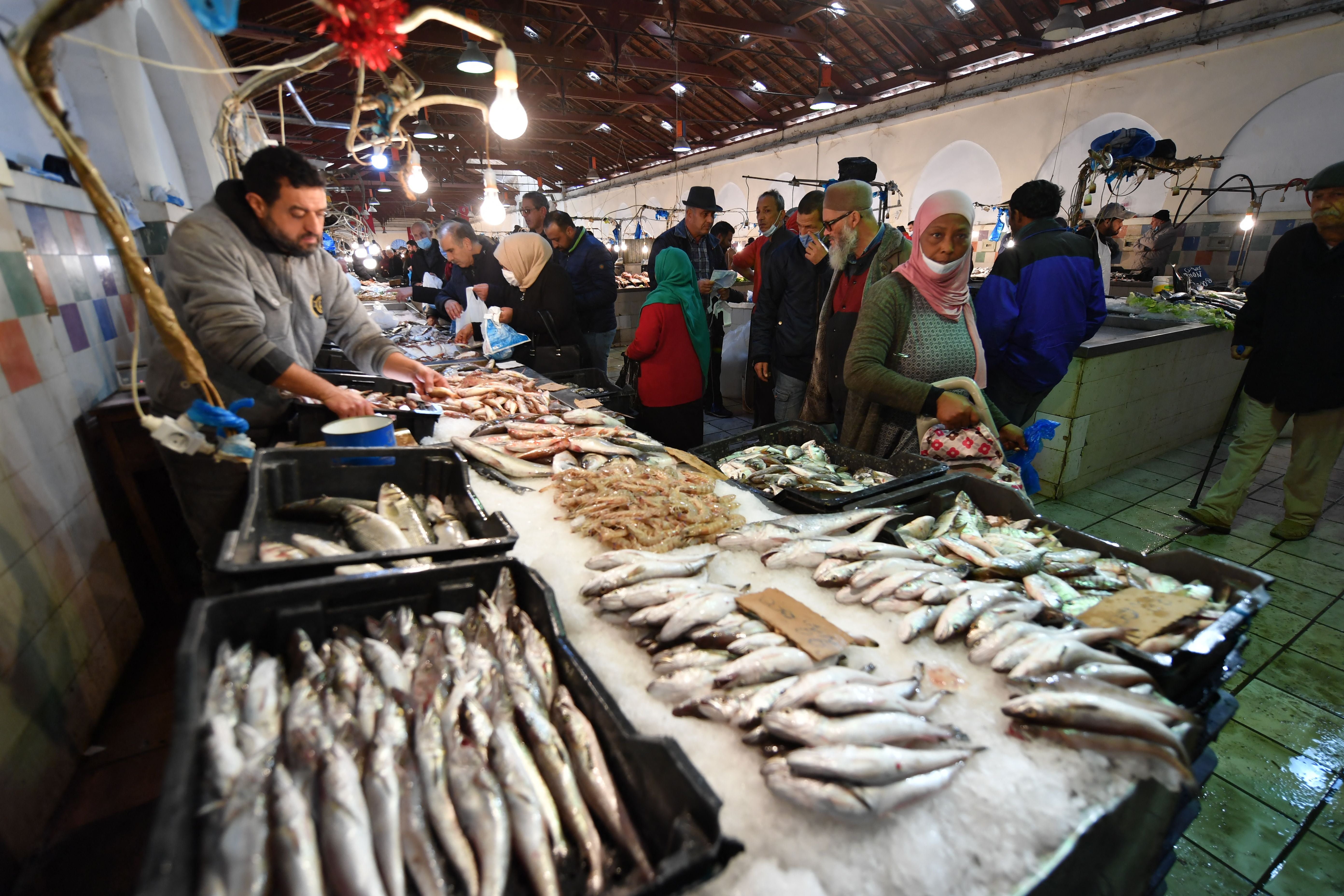 File photo: People shop in a fish market in Tunis, the capital of Tunisia, 14 December 2021