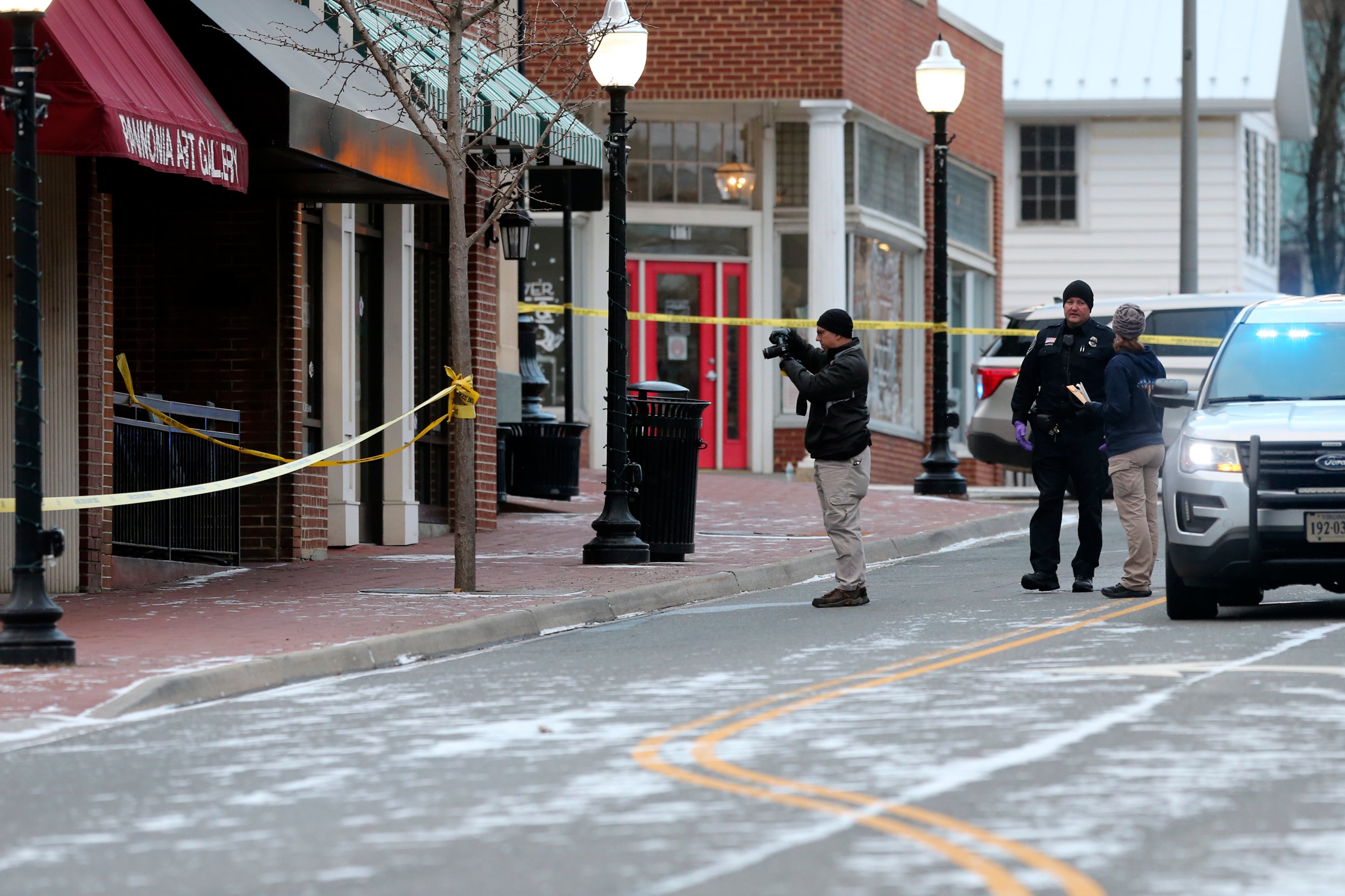 Investigators are seen outside Melody Hookah Lounge in downtown Blacksburg on Saturday following the shooting the night before