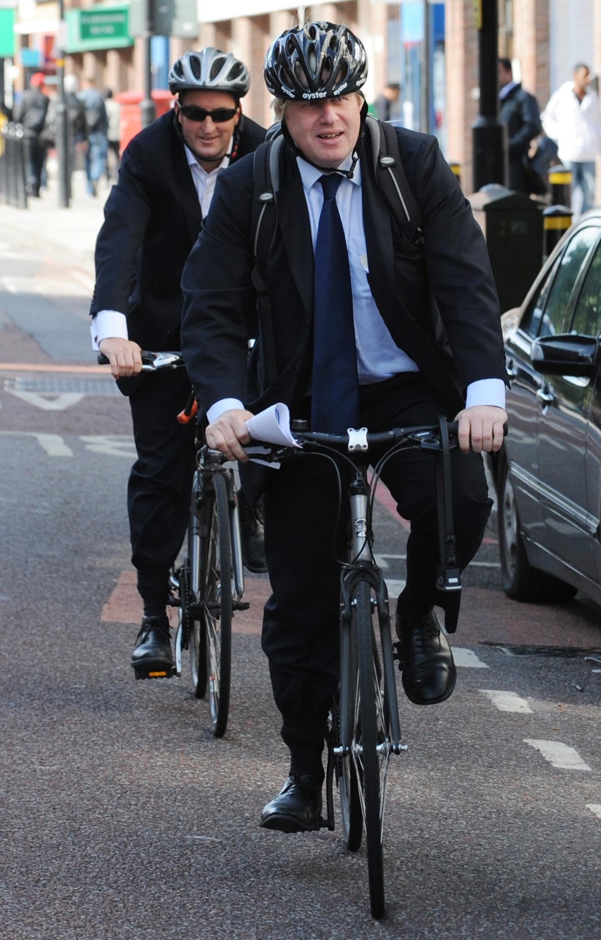 Boris Johnson arriving at the East London Mosque with Guto Harri (Stefan Rousseau/PA)