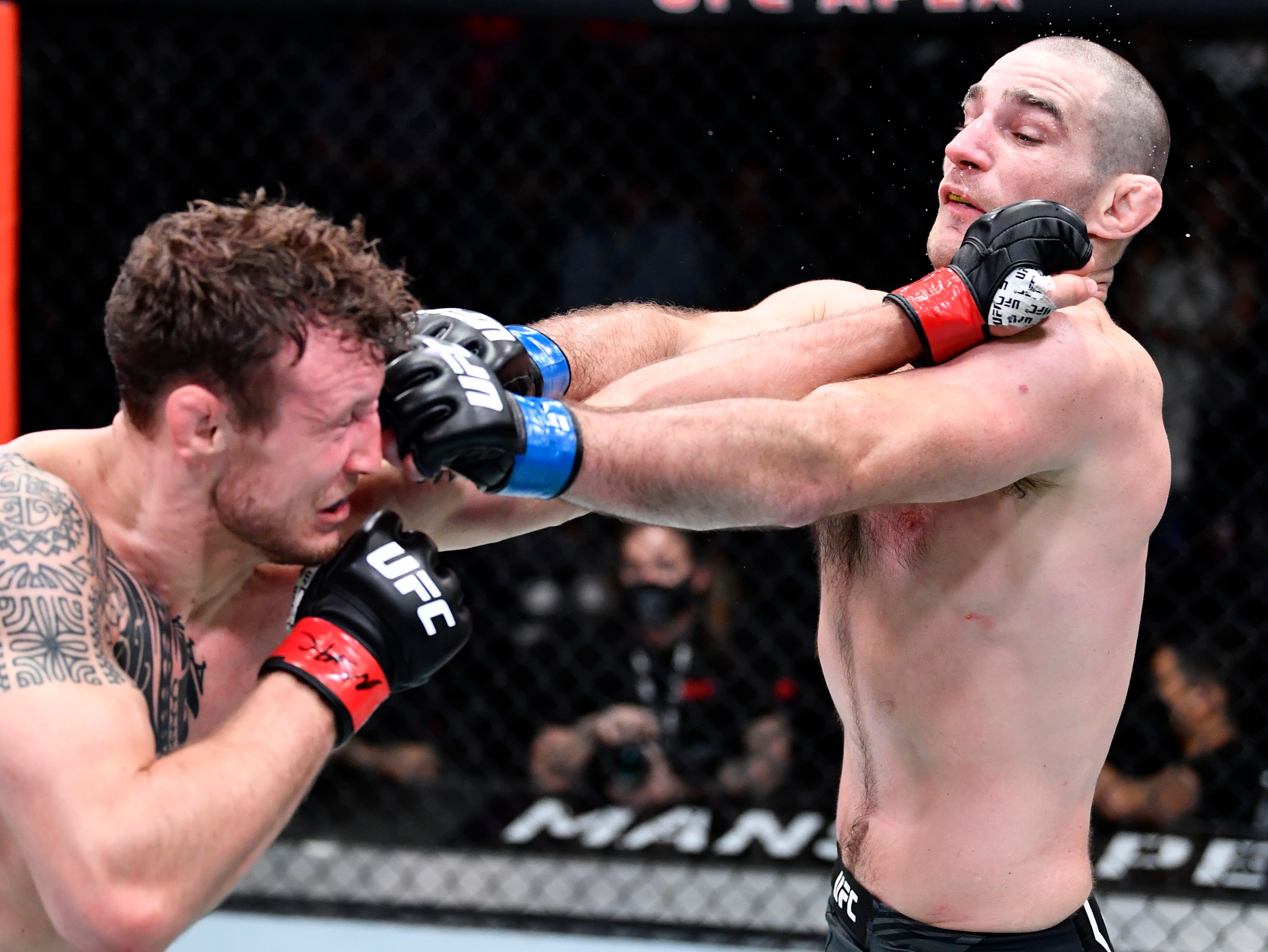 Sean Strickland (right) slips a punch while landing his own on Jack Hermansson