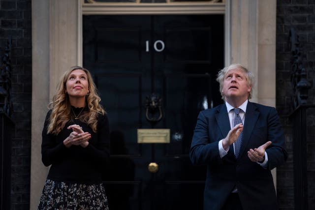 <p>Prime Minister Boris Johnson and his wife Carrie stand in Downing Street (Victoria Jones/PA)</p>