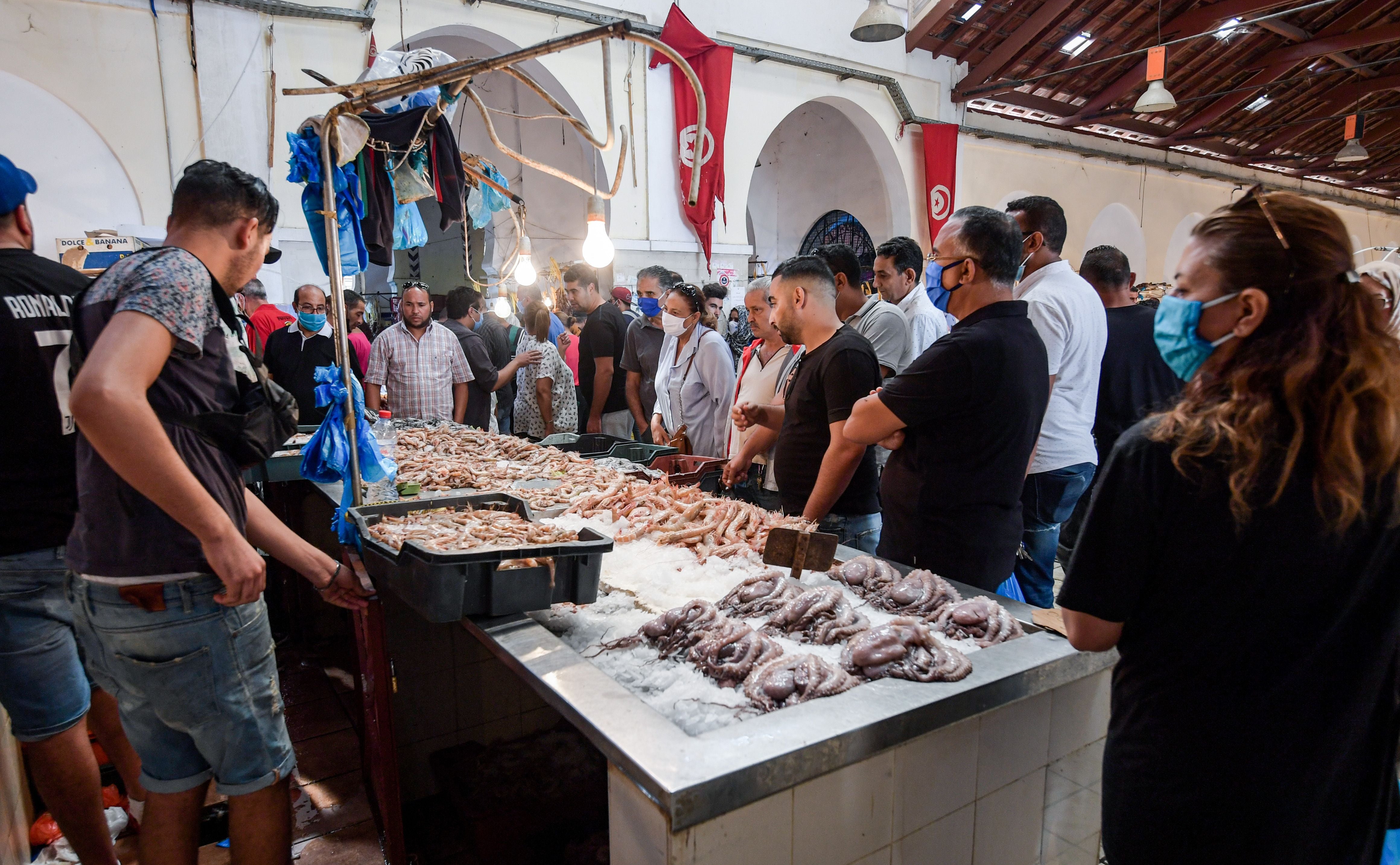 Customers browse fish at stalls at the central market in Tunisia’s capital Tunis on 4 October2020