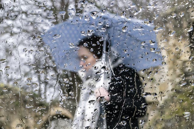<p>A woman with an umbrella near Knaresborough Castle in North Yorkshire on 5 February 2022 </p>