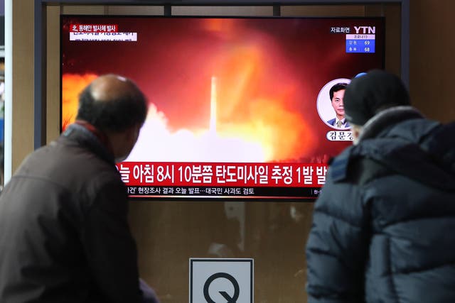 <p>People watch a TV at the Seoul Railway Station showing a file image of a North Korean missile launch, on January 05, 2022 in Seoul, South Korea</p>