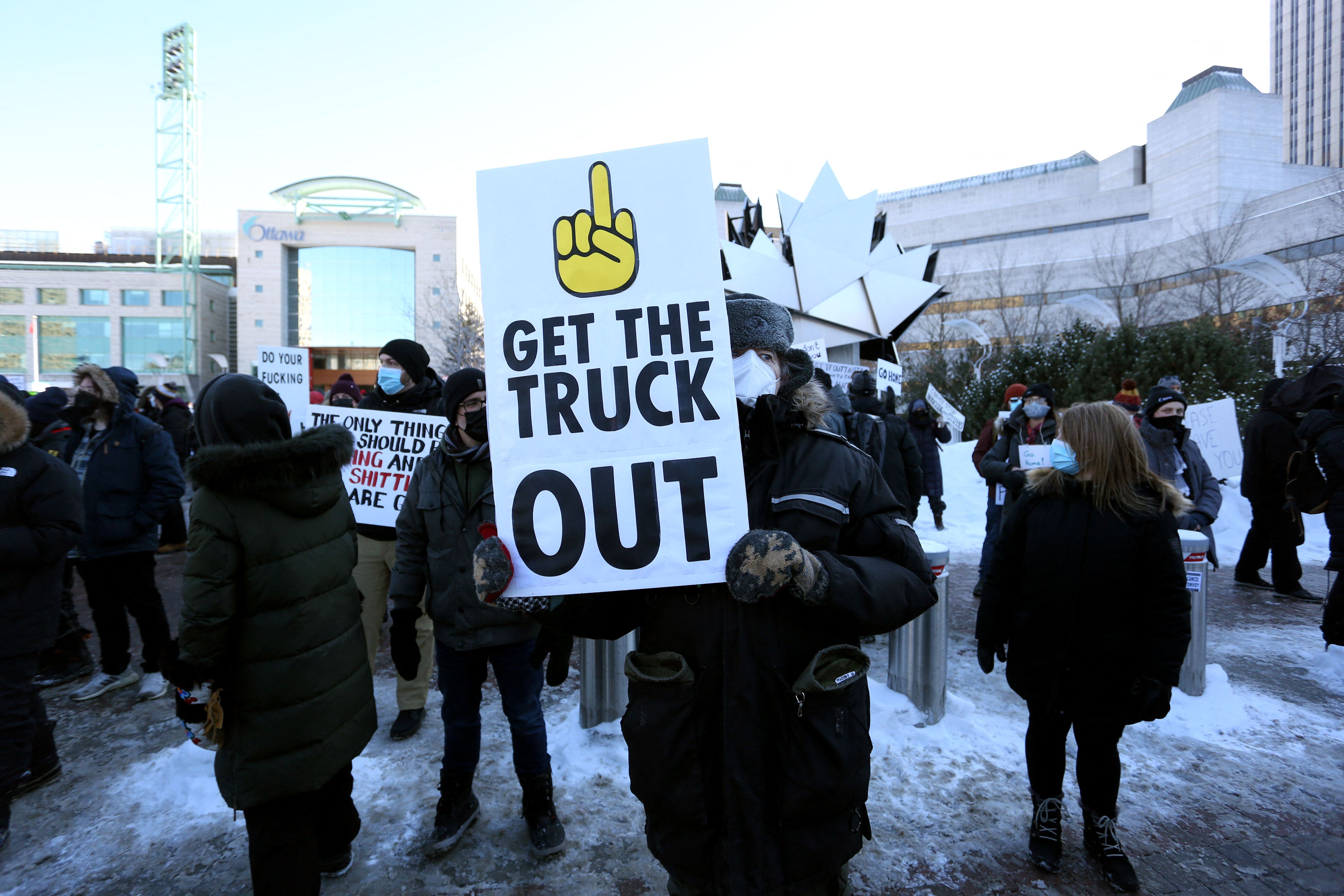 A protester holds a sign as truckers and supporters protest against mandates and restrictions related to Covid-19 vaccines