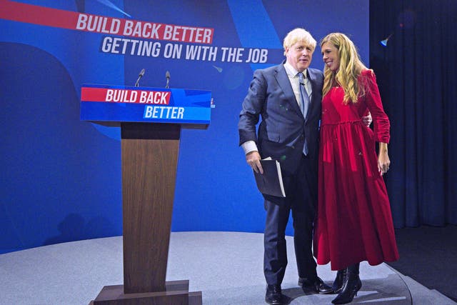 <p>Prime minister Boris Johnson is joined by his wife Carrie on stage after delivering his keynote speech at the 2021 Conservative Party conference in Manchester</p>