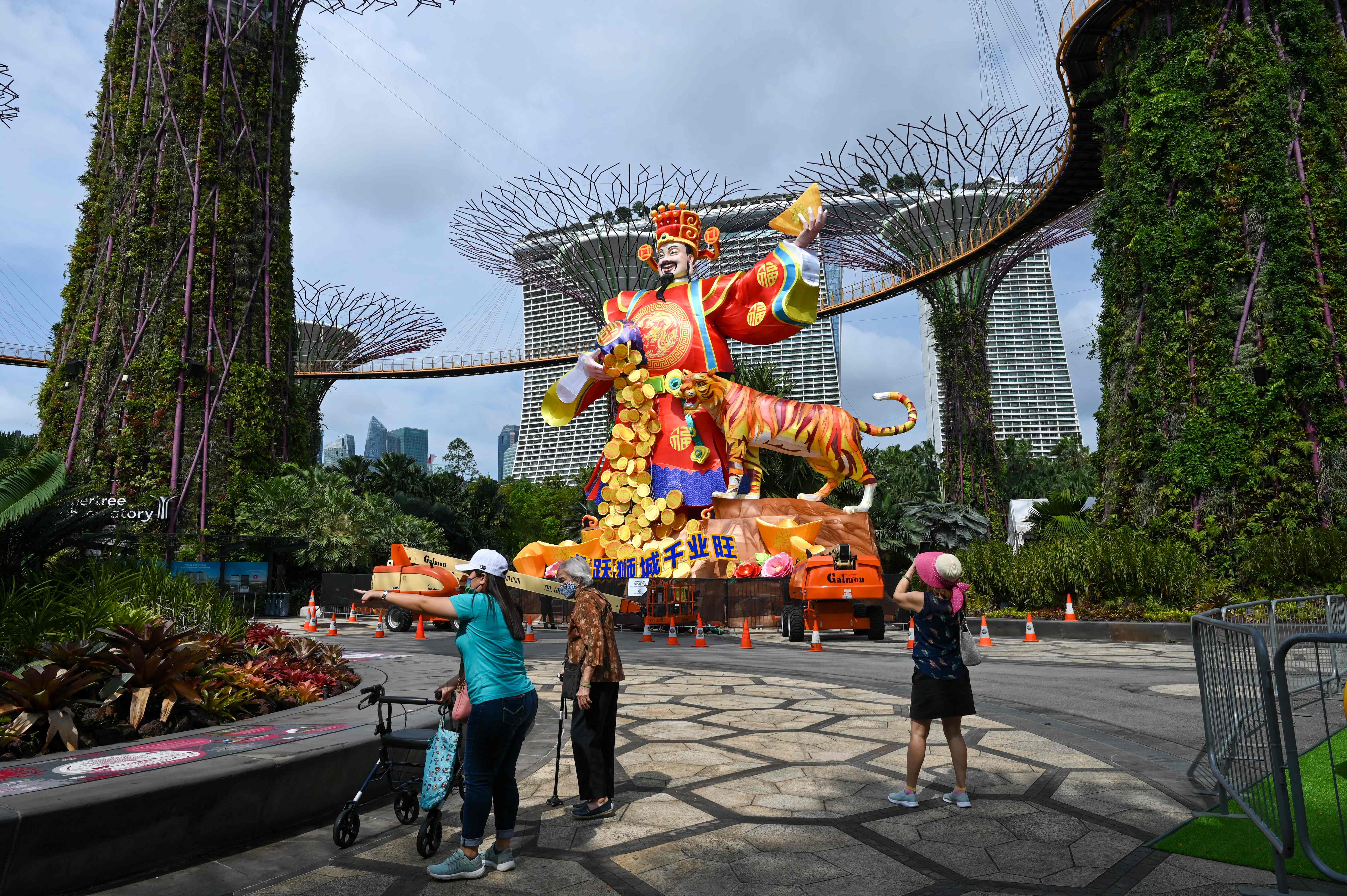 People admire the God of Fortune lantern figurine in Singapore, 18 January 2022