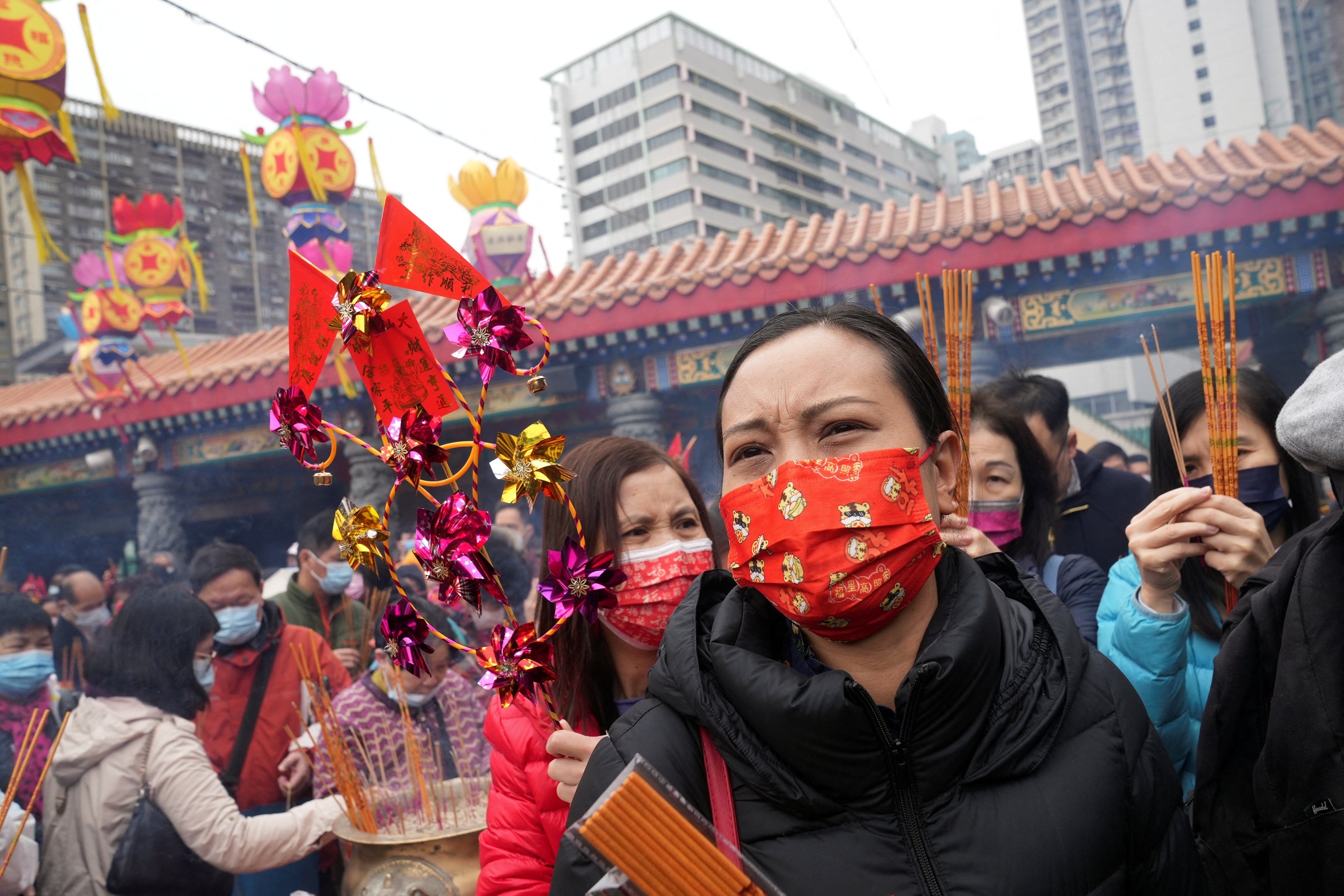 Worshippers wearing face masks visit the Wong Tai Sin temple in Hong Kong, 4 February 2022