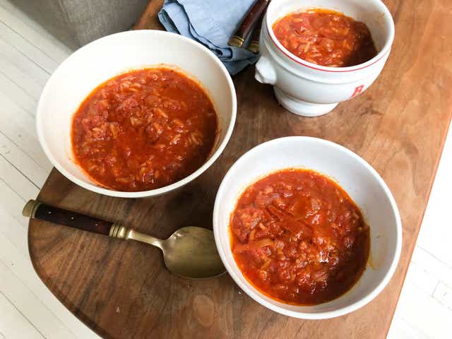 <p>The flavour of this tomato soup with rice is extra rich thanks to caramelised tomato paste</p>