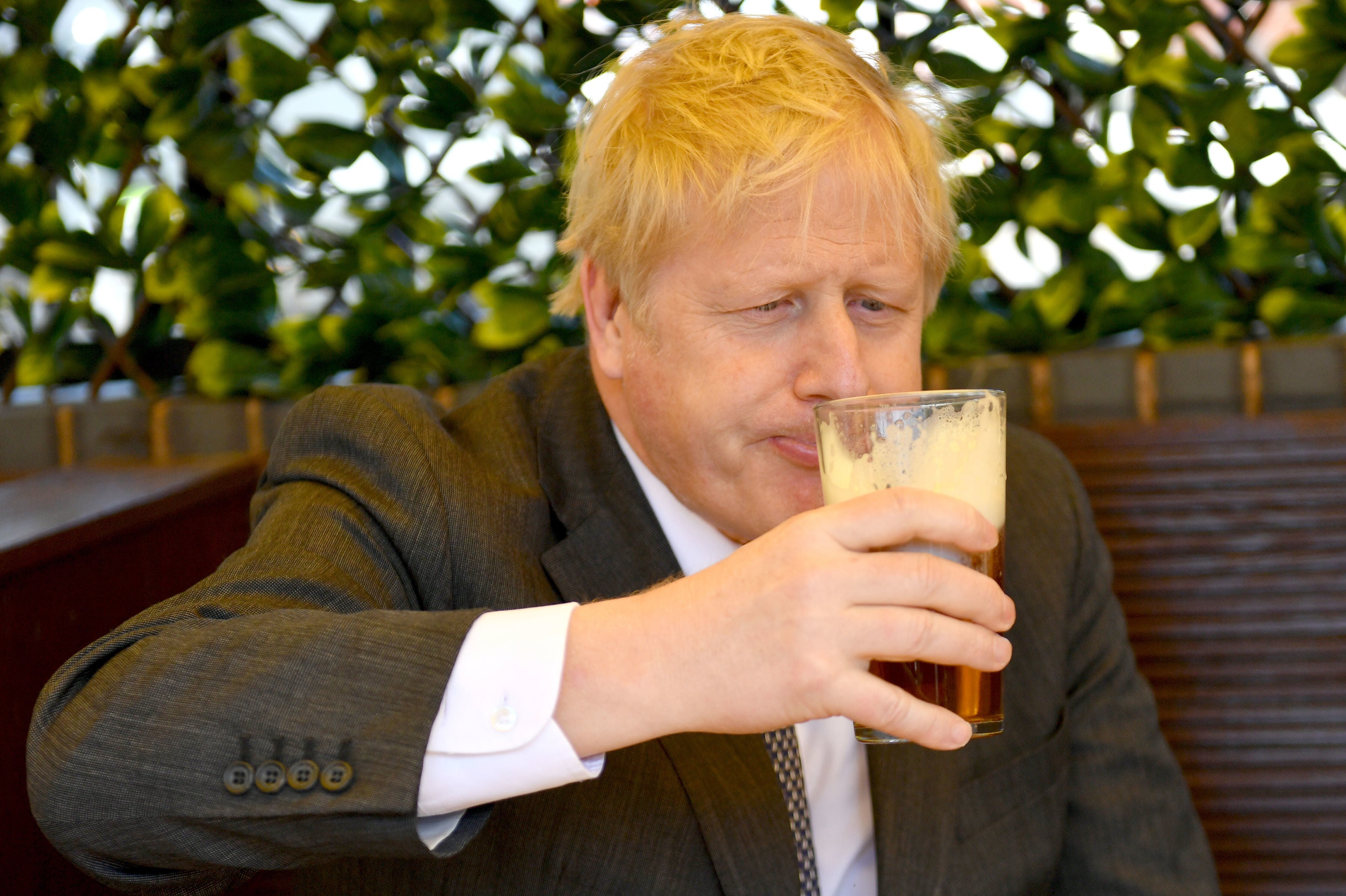 British Prime Minister Boris Johnson sips a pint in Wolverhampton, United Kingdom, 19 April 2021