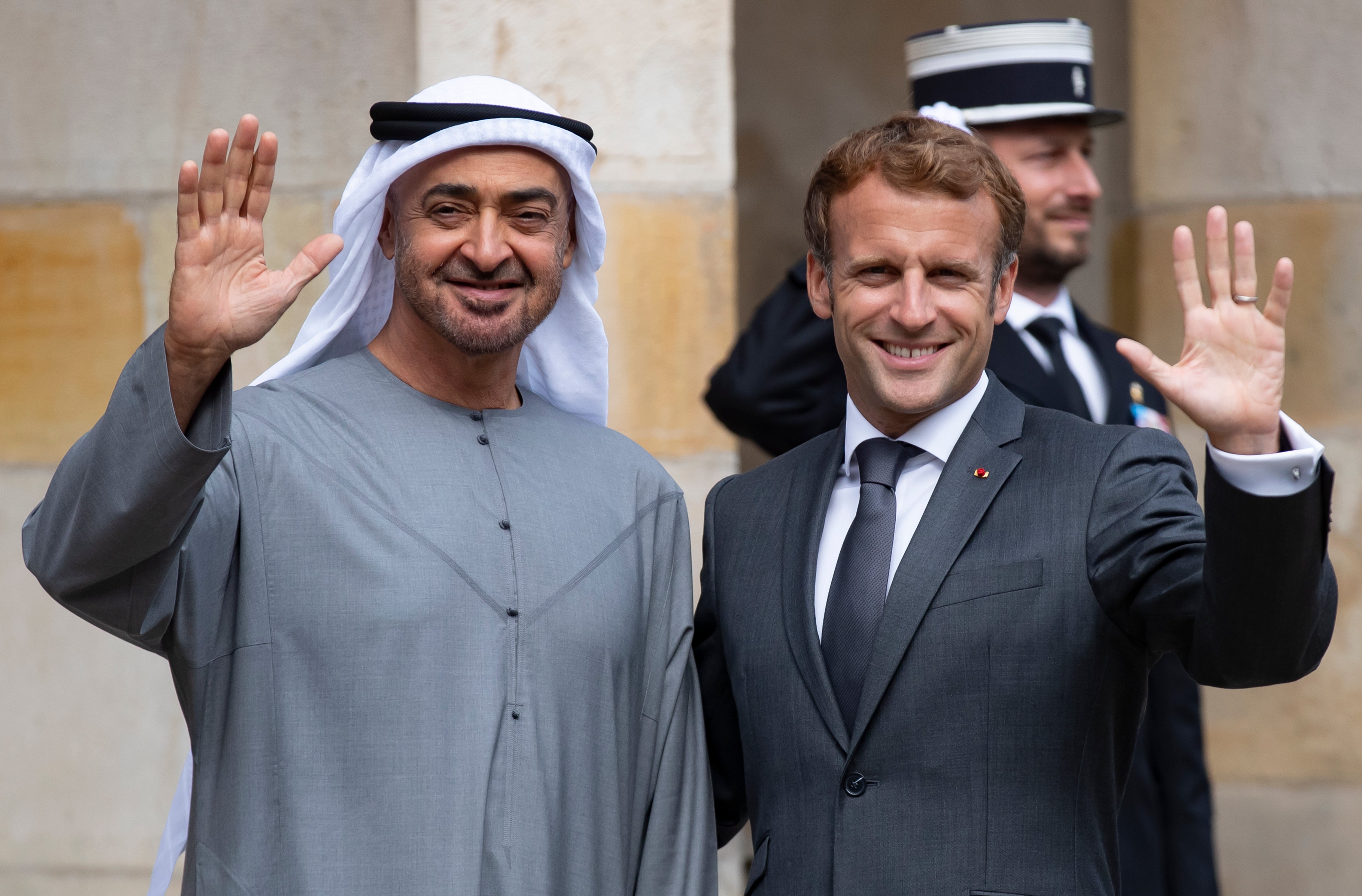 French President Emmanuel Macron (R) greets and Crown Prince of Abu Dhabi and Deputy Supreme Commander of the UAE Armed Forces, Sheikh Mohamed bin Zayed Al Nahyan