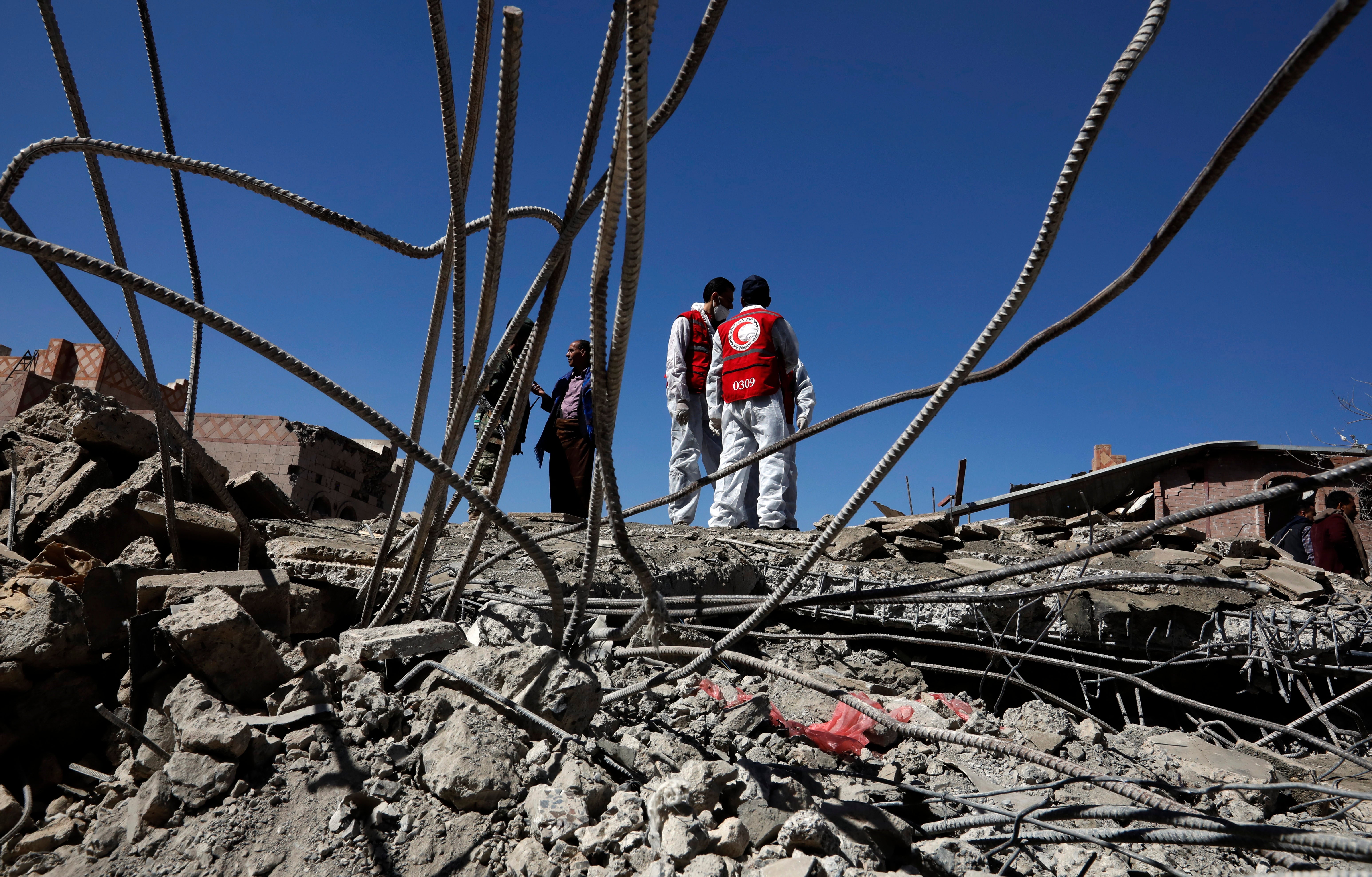 Yemeni rescuers search for survivors under the wreckage of buildings a day after Saudi-UAE-led airstrikes hit a neighborhood in Sana’a last month