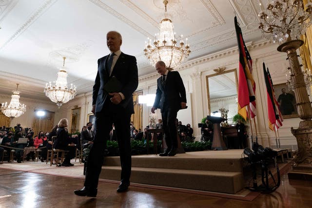 <p>US President Joe Biden (L) and German Chancellor Olaf Scholz depart following a press conference in the East Room of the White House in Washington, DC, on February 7, 2022</p>