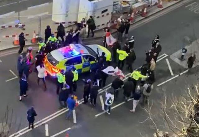 Video grab image of clashes between police and protesters in Westminster as officers use a police vehicle to escort Labour leader Sir Keir Starmer to safety (Conor Noon)