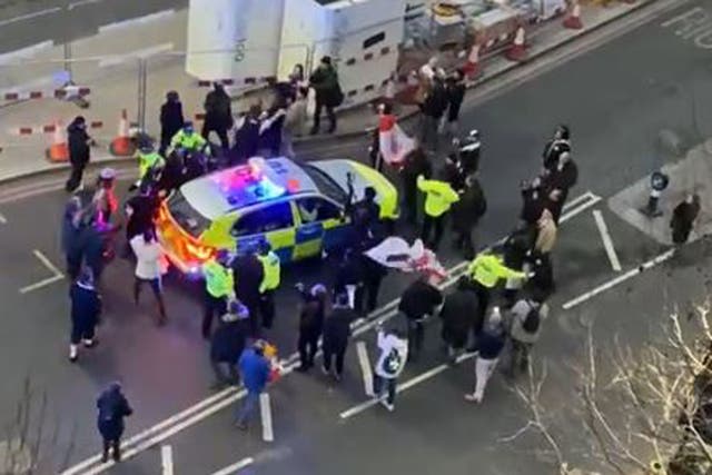 Video grab image of clashes between police and protesters in Westminster as officers use a police vehicle to escort Labour leader Sir Keir Starmer to safety (Conor Noon)