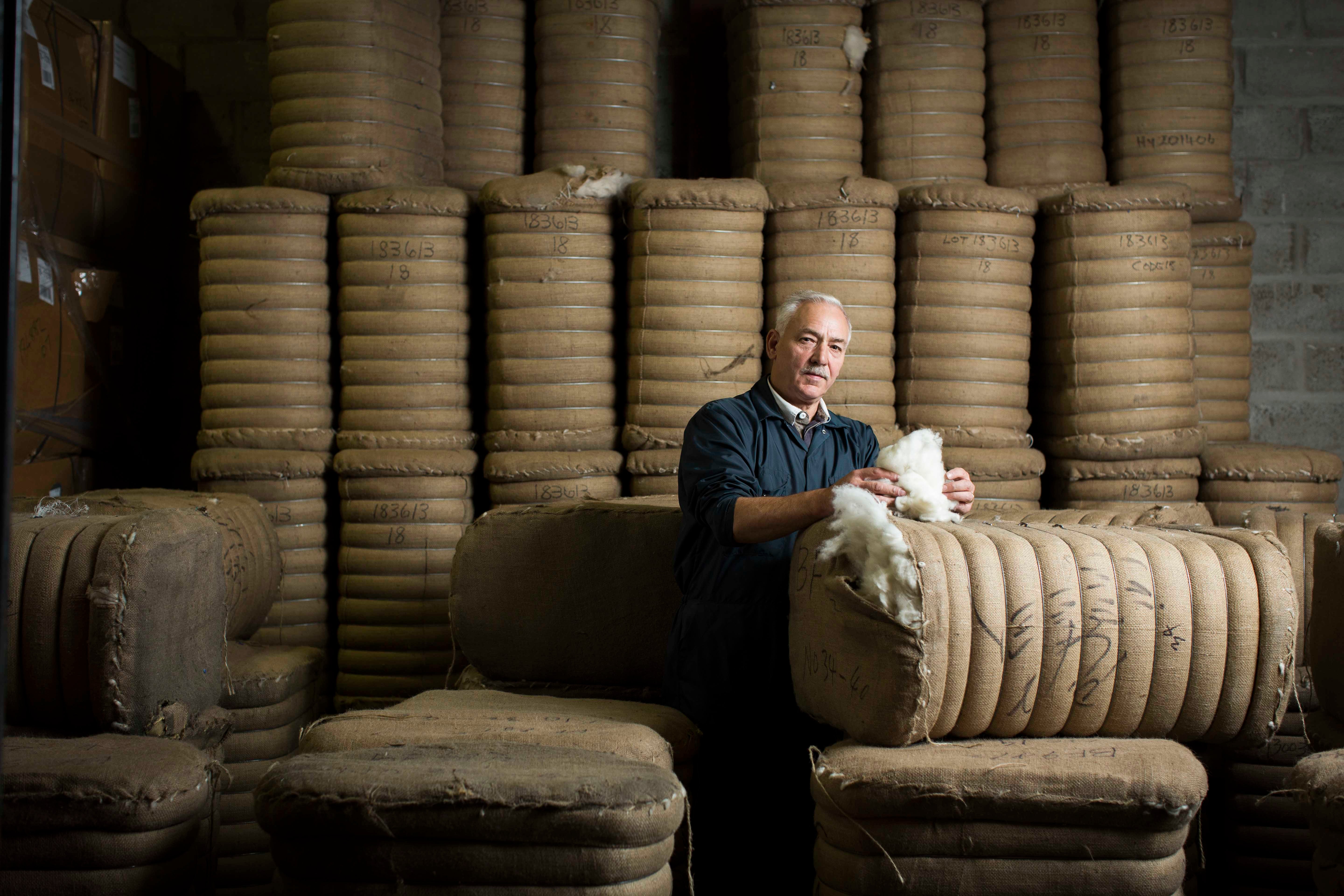 A Johnstons of Elgin wool store operative handling cashmere, which must be stored in hessian sacks so it can breathe