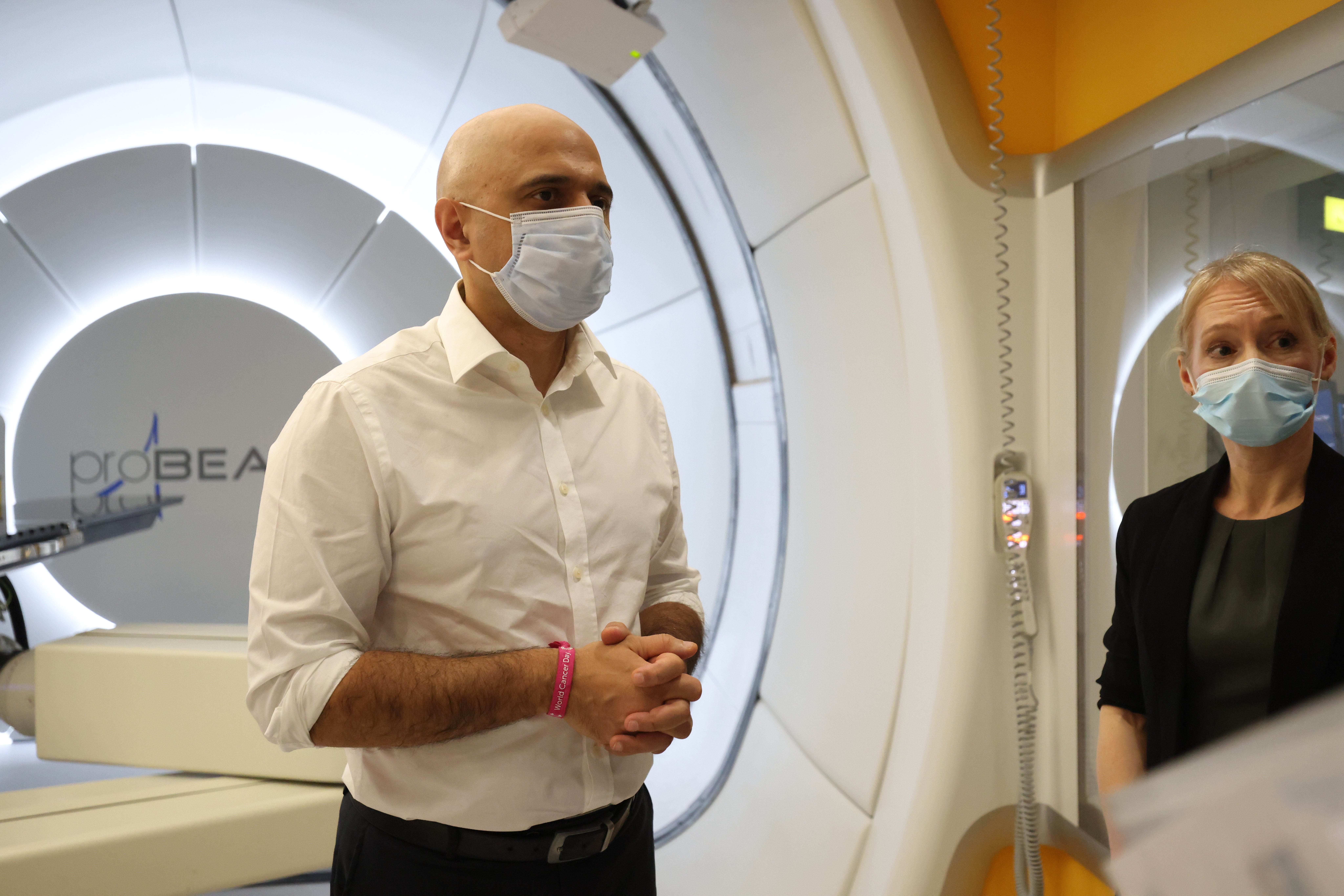 Health Secretary Sajid Javid with therapeutic radiographer Laura Allington as he views the proton beam scanner at University College Hospital in London (PA)